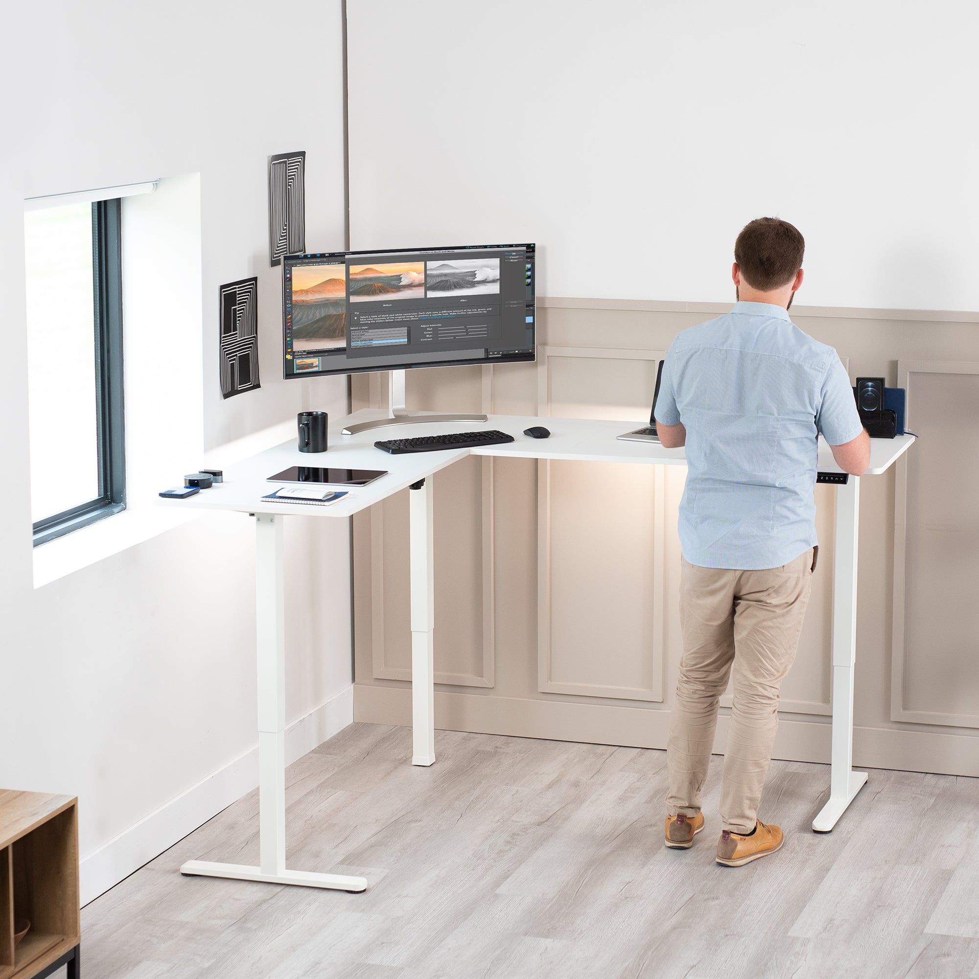 Electric heavy-duty corner desk workstation for modern office workspaces.