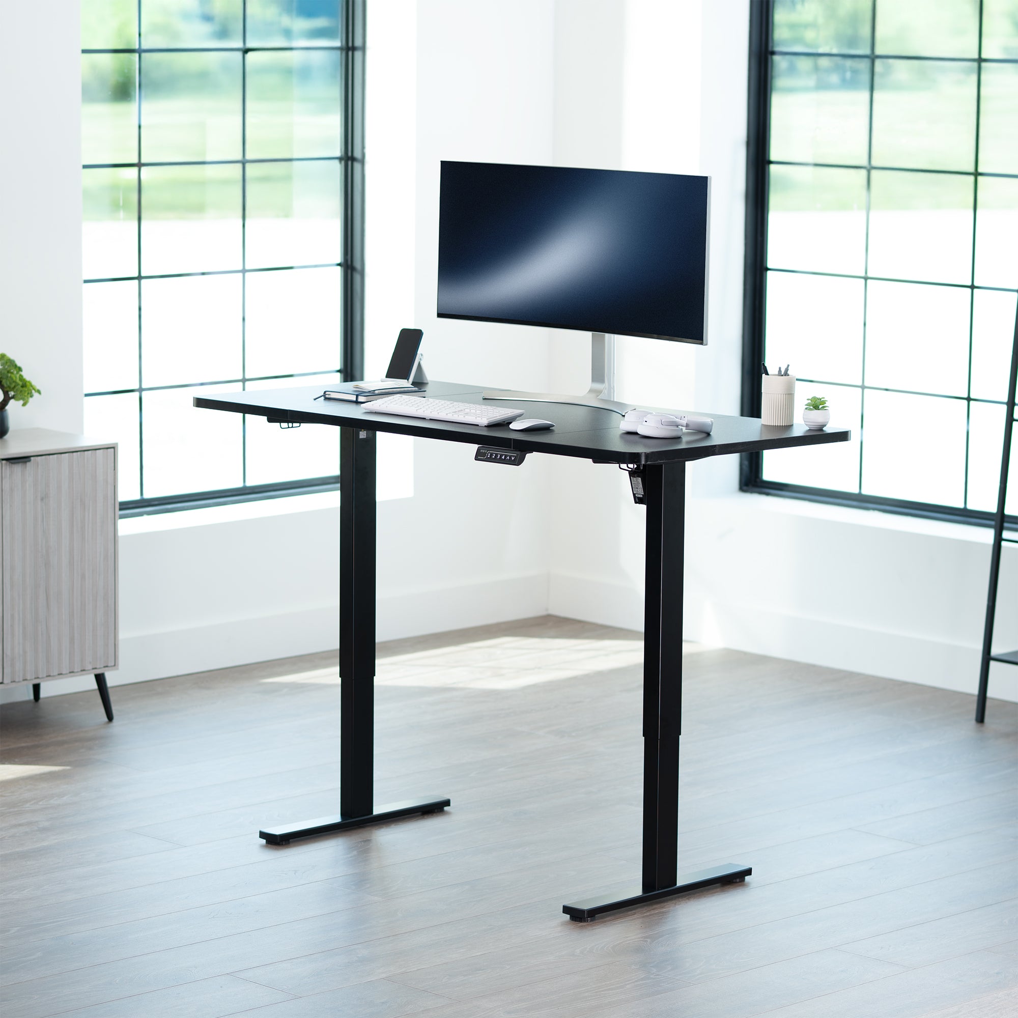 Sturdy ergonomic sit or stand active desk workstation with adjustable height using smart control panel.