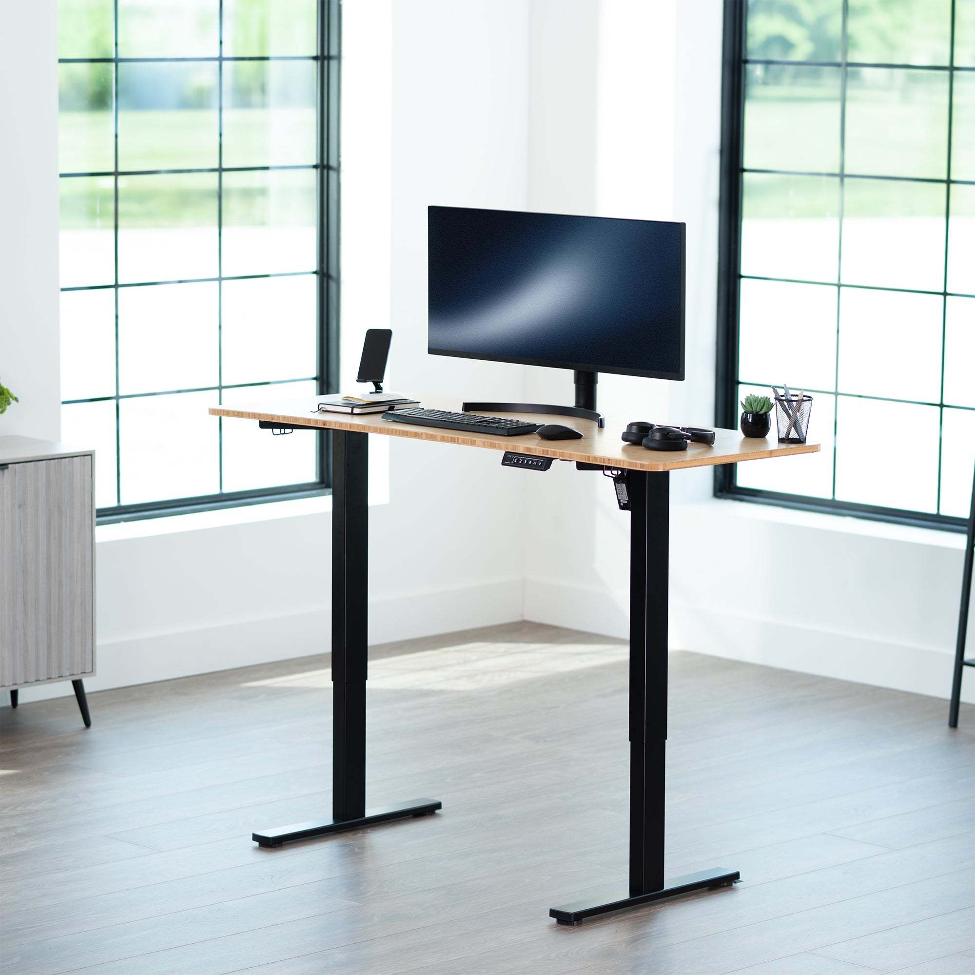 Sturdy ergonomic sit or stand active desk workstation with adjustable height using smart control panel.