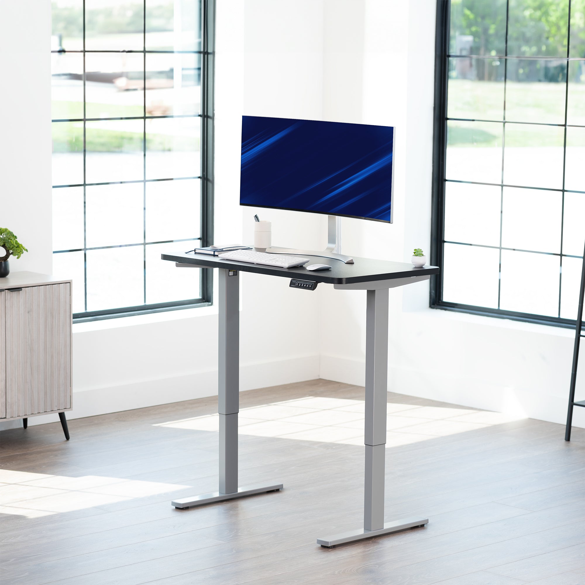 Sturdy ergonomic sit or stand active desk workstation with adjustable height using smart control panel.