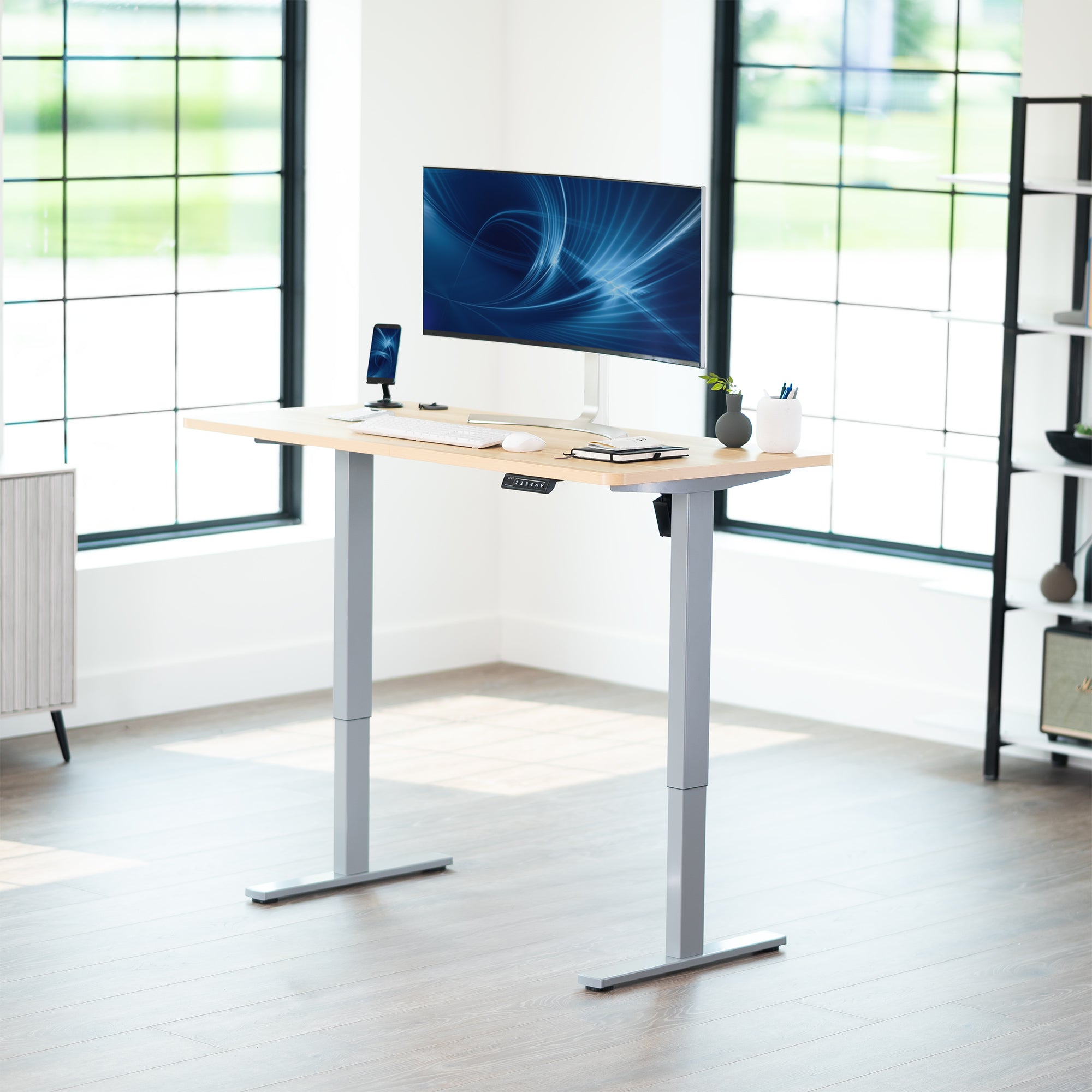 Sturdy ergonomic sit or stand active desk workstation with adjustable height using smart control panel.