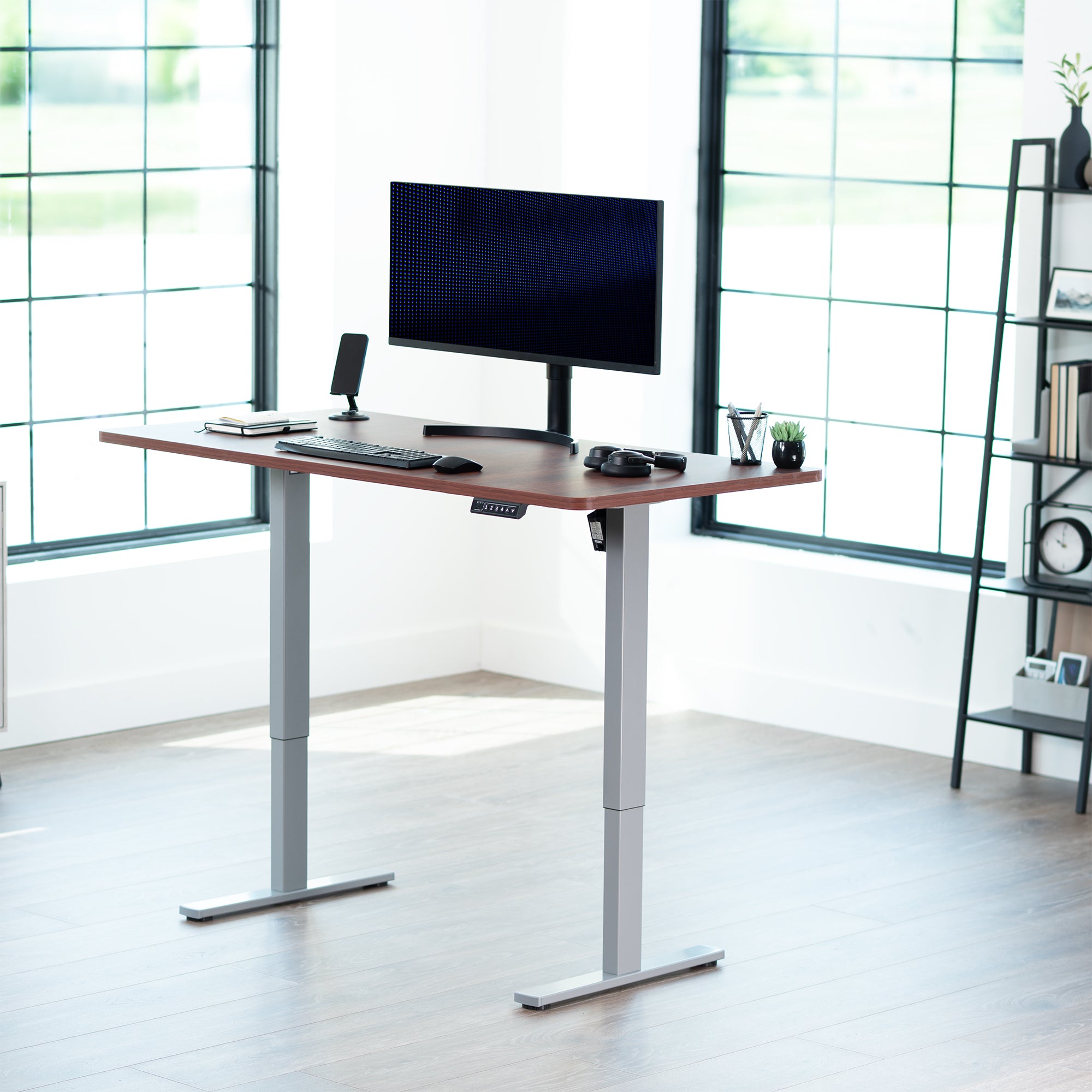 Sturdy ergonomic sit or stand active desk workstation with adjustable height using smart control panel.
