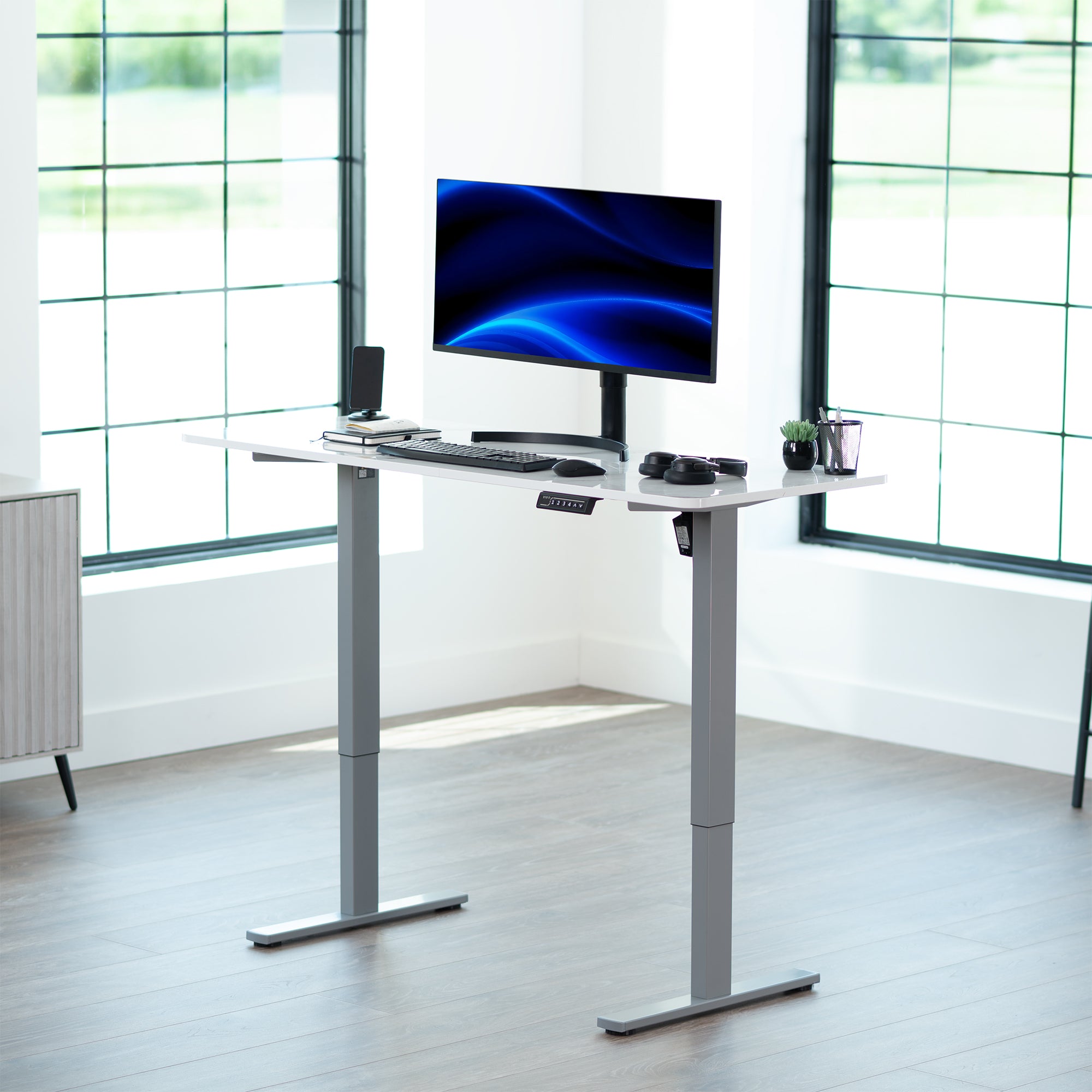 Sturdy ergonomic sit or stand active desk workstation with adjustable height using smart control panel.