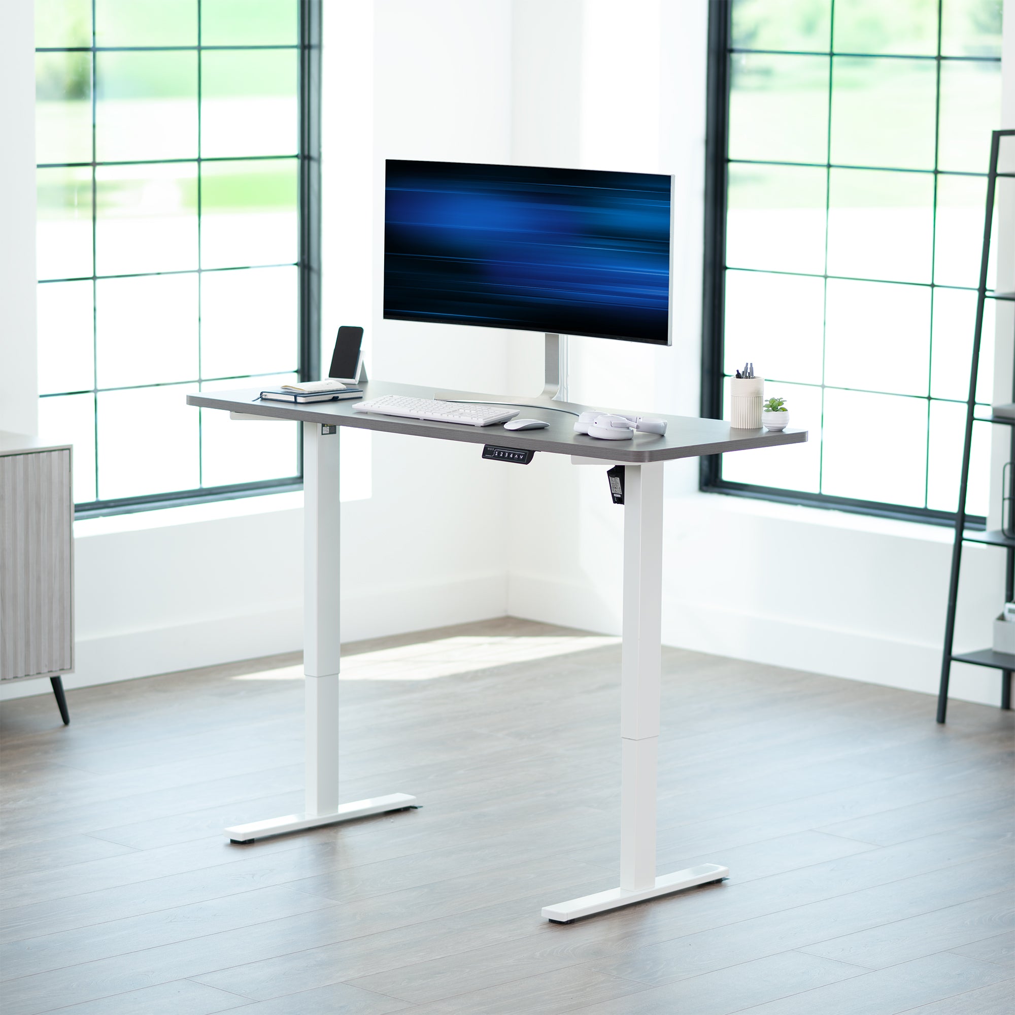Sturdy ergonomic sit or stand active desk workstation with adjustable height using smart control panel.