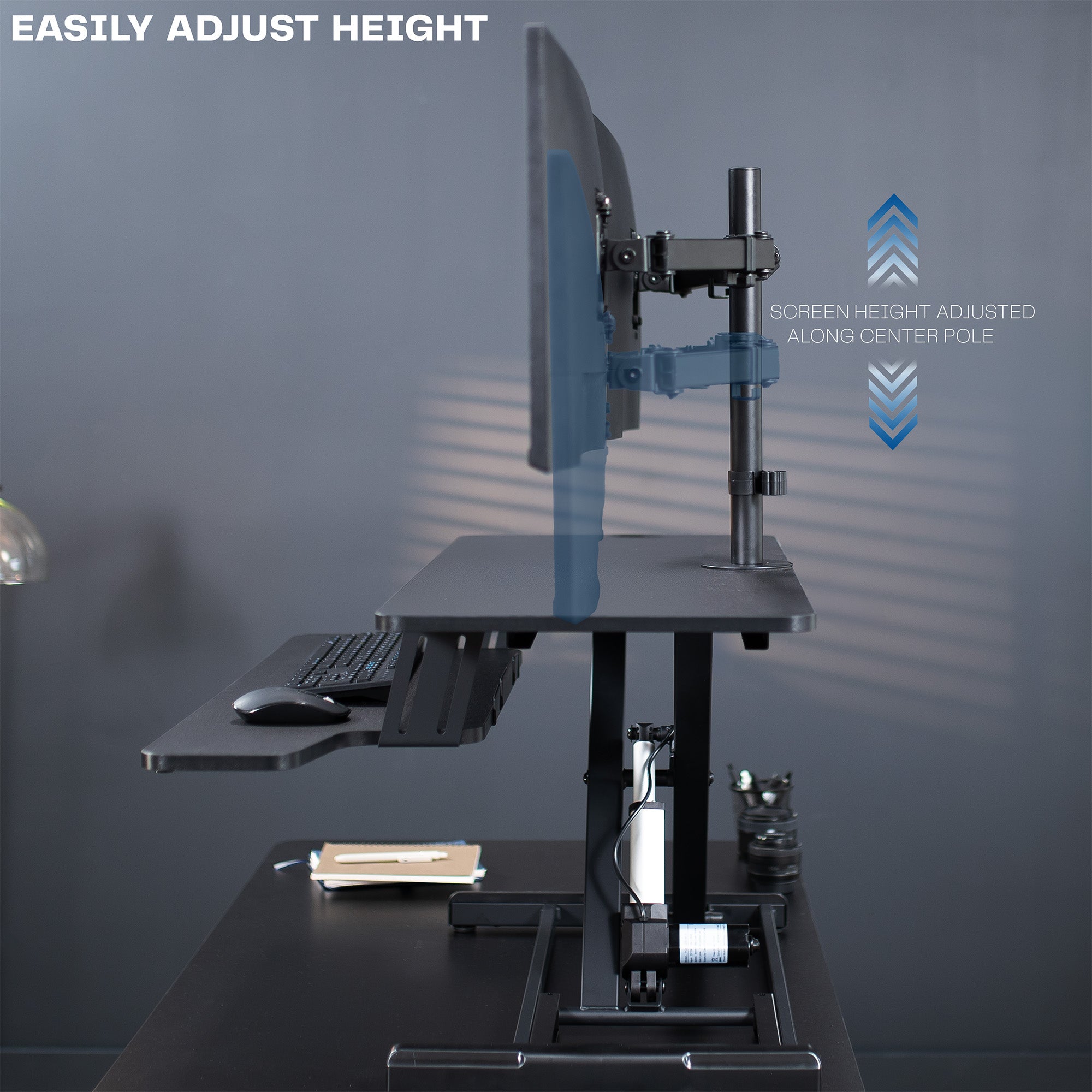 Sit to stand desk riser and dual monitor mount with electric height adjustment.