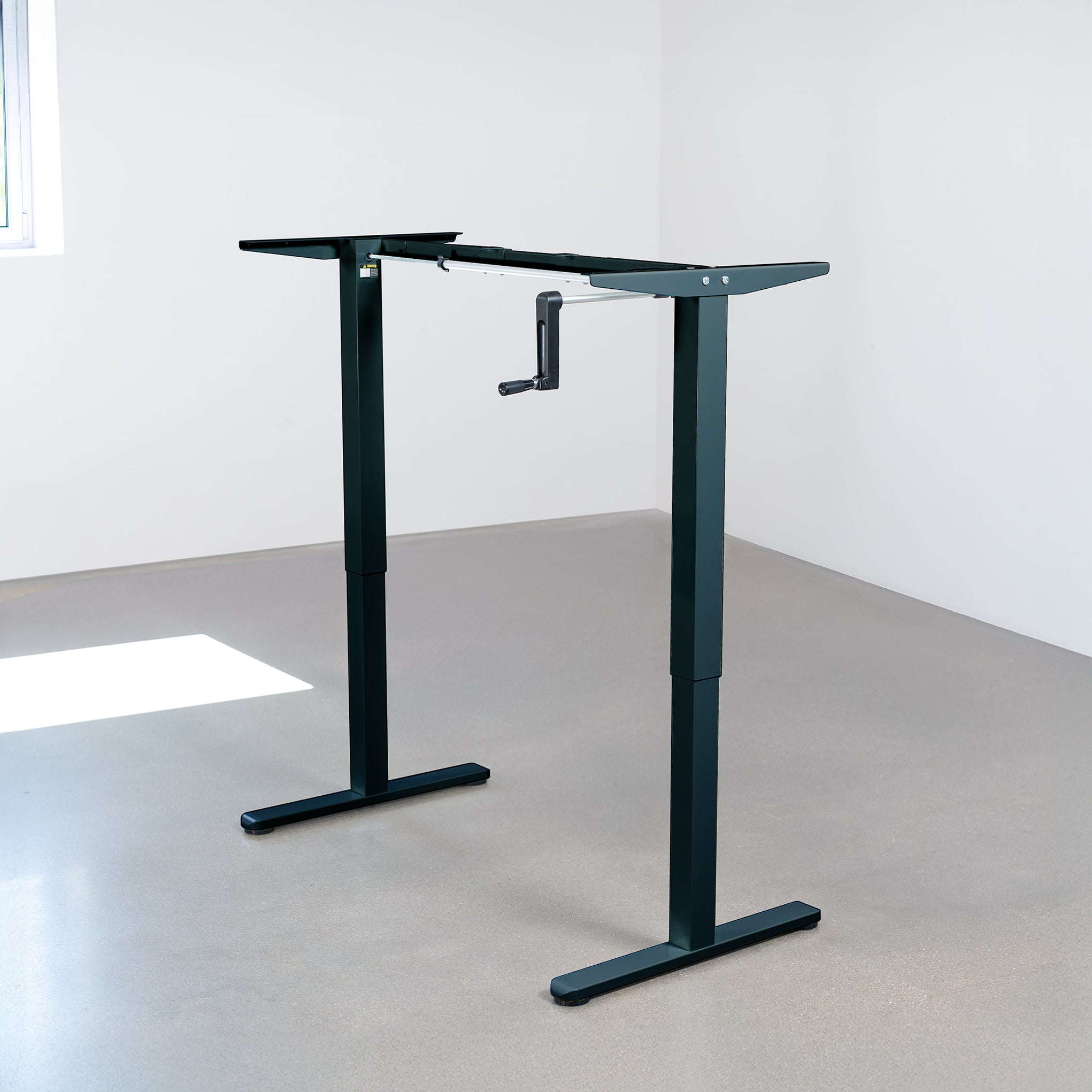 Compact steel desk frame with brown desktop and a dual monitor mount.