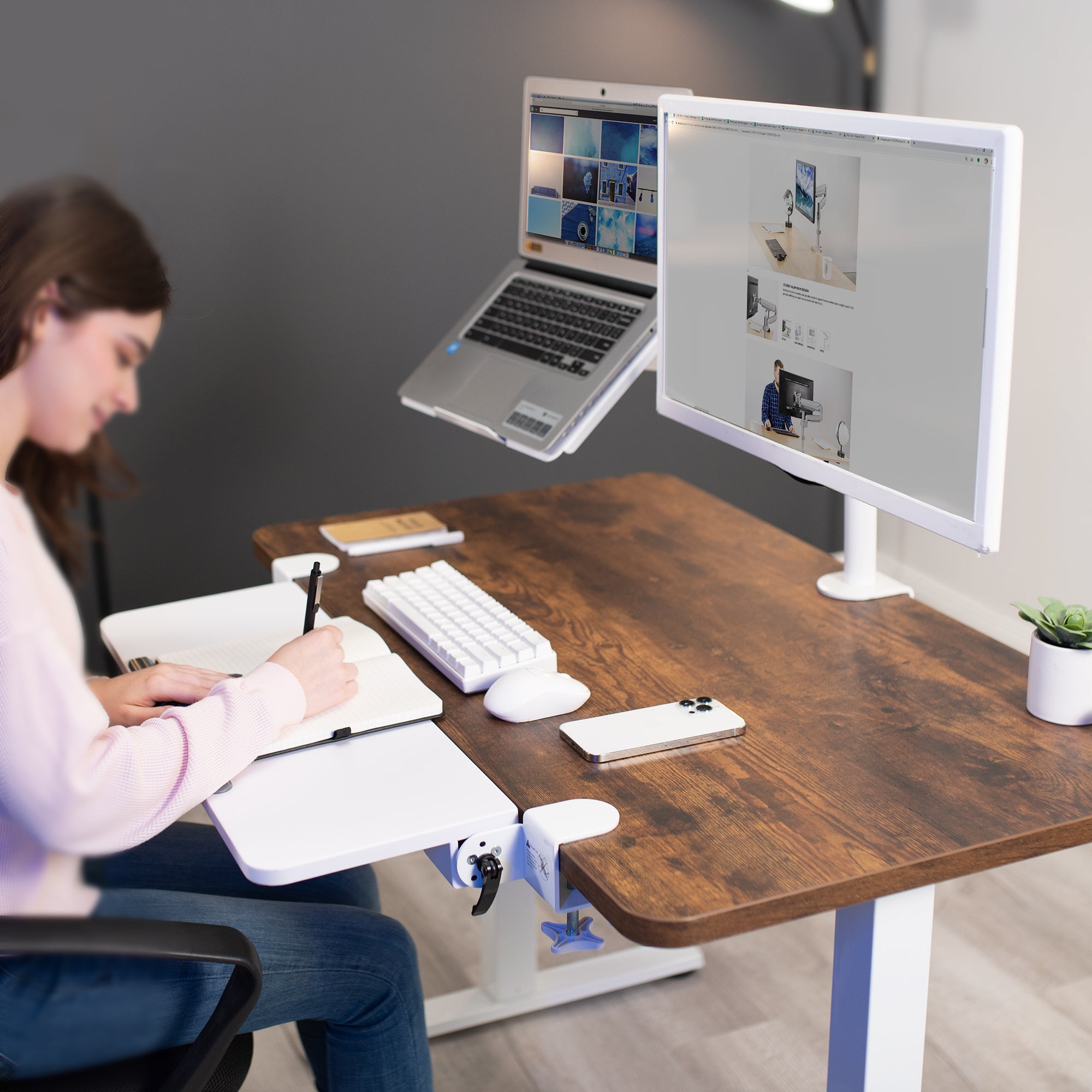 Person working at a desk with a white desk extension.