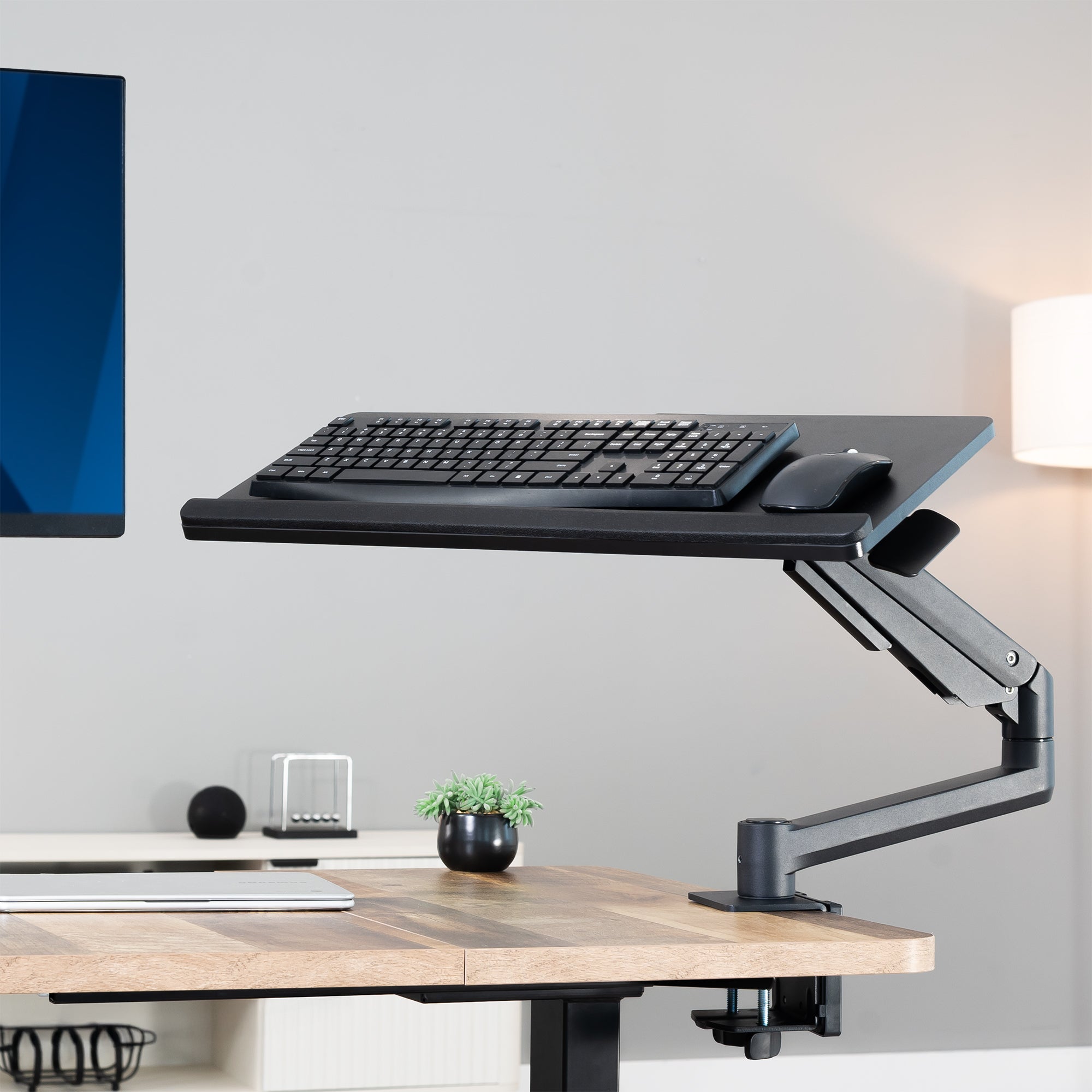 Adjustable Pneumatic Clamp-on Keyboard Tray in a home office setting