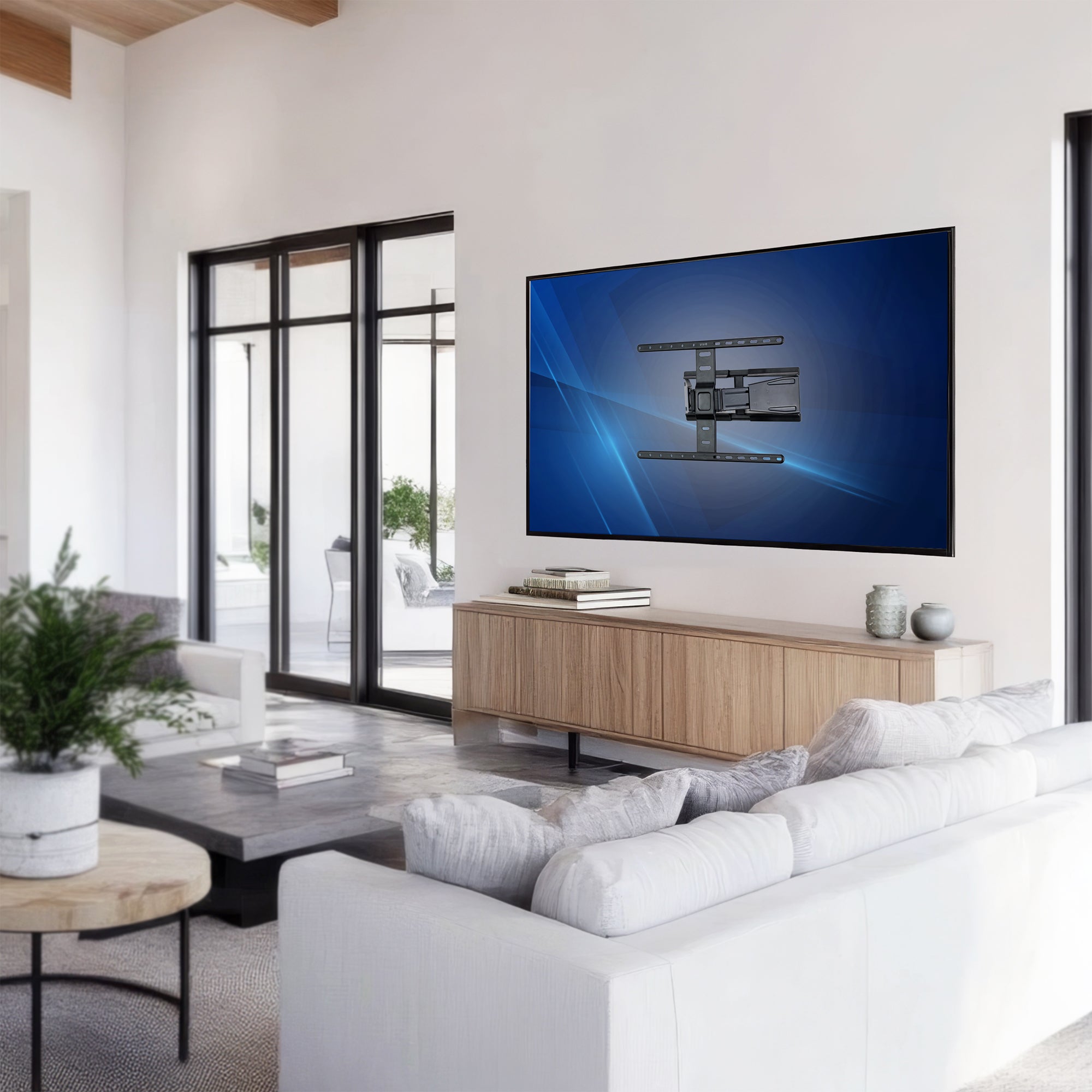 Modern living room with a large TV mounted on the wall, white sofa, and wooden coffee table.