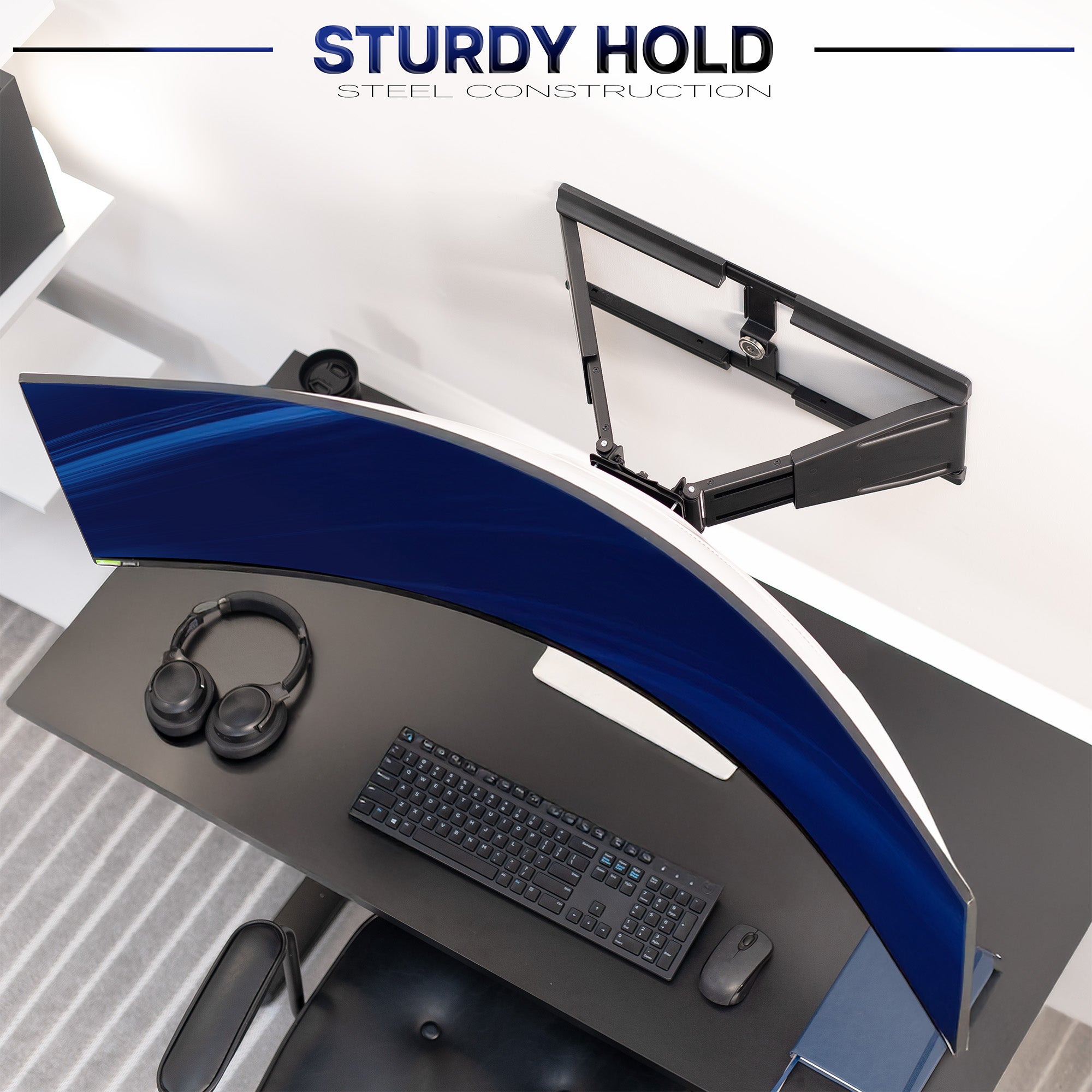 Modern office desk setup with a sturdy steel monitor wall mount, keyboard, mouse, and headphones on a white background.