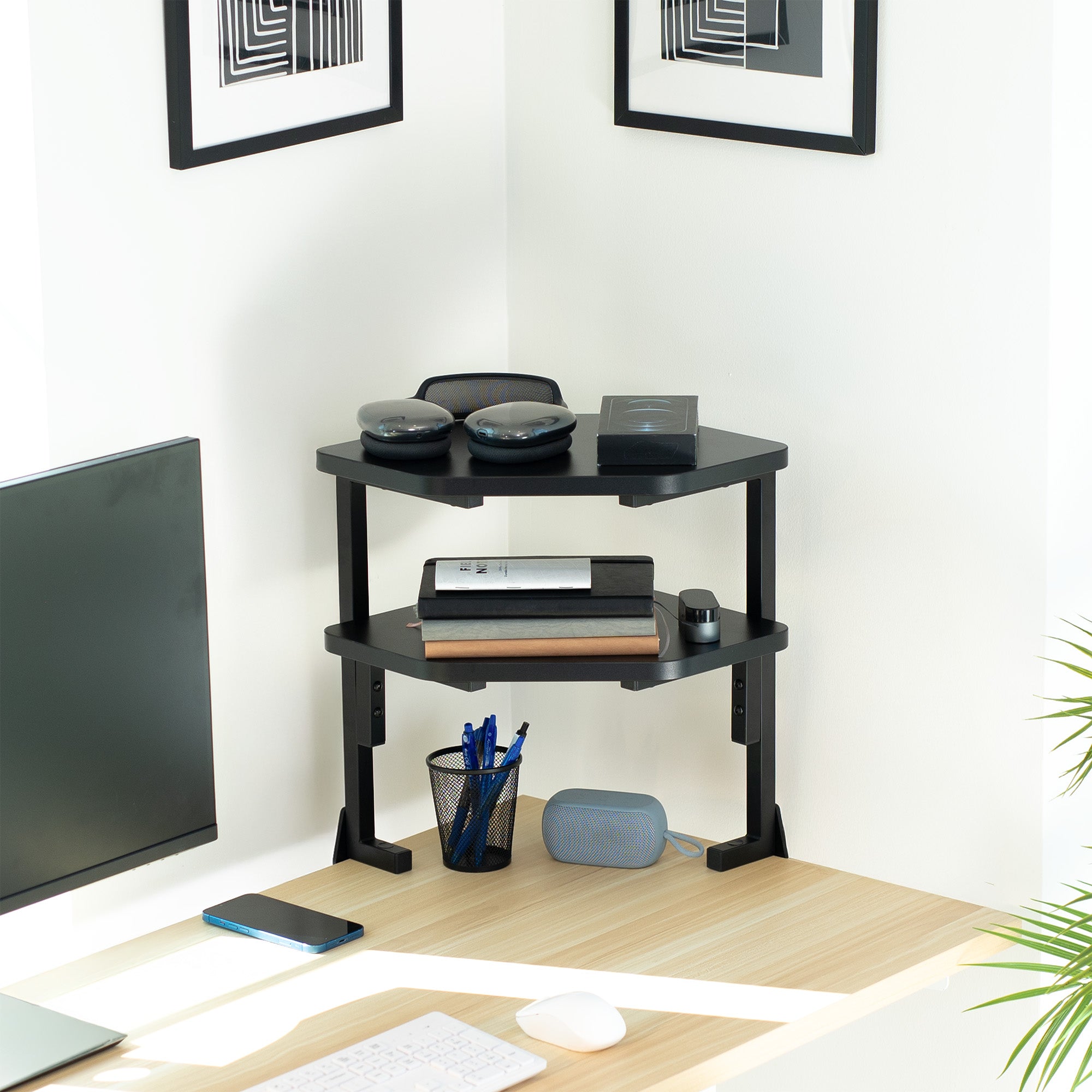 Black corner desk shelf with office items in a home office setting