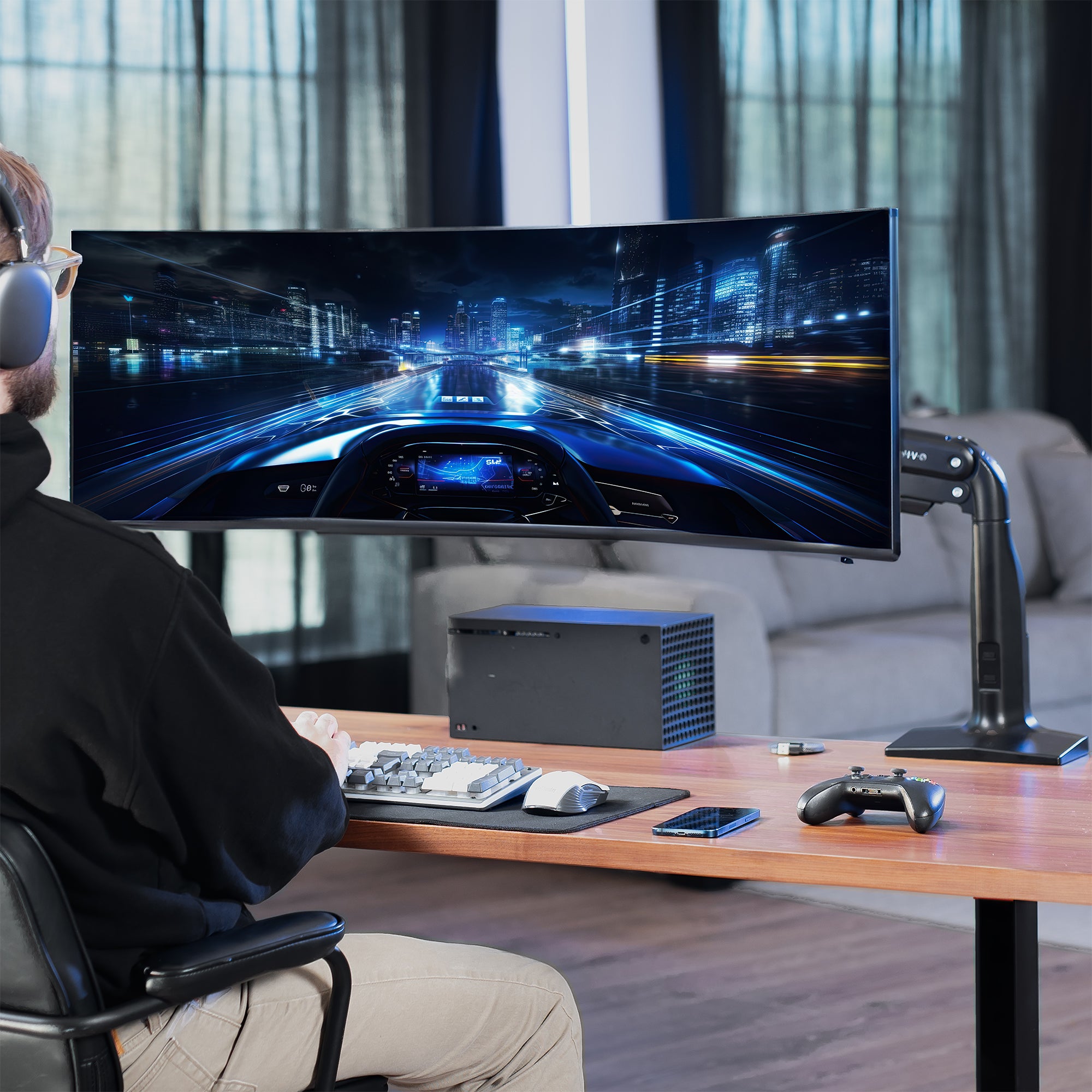 Person playing a racing game on a large monitor in a modern living room.