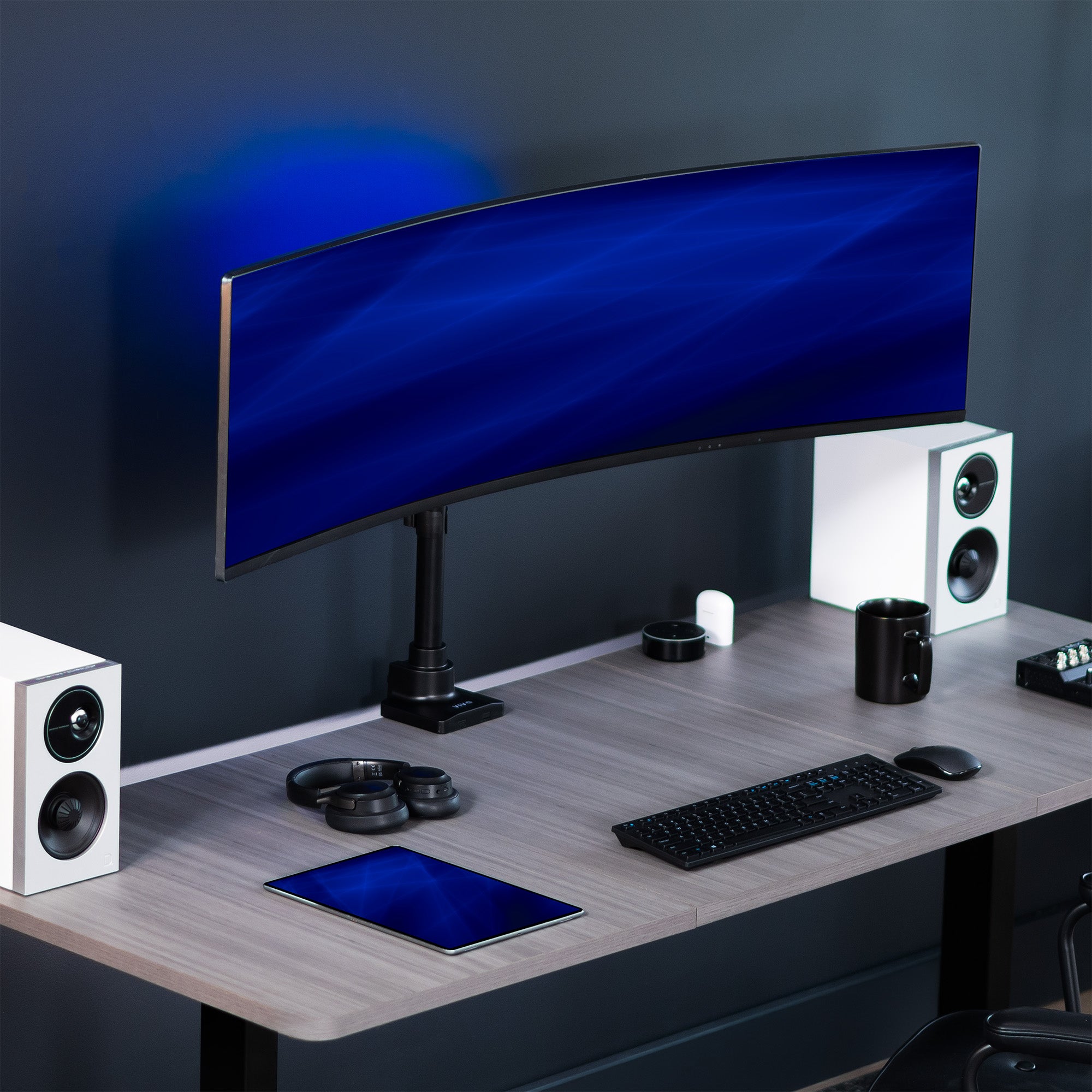 Low profile TV desk mount with articulating arm with cable management.