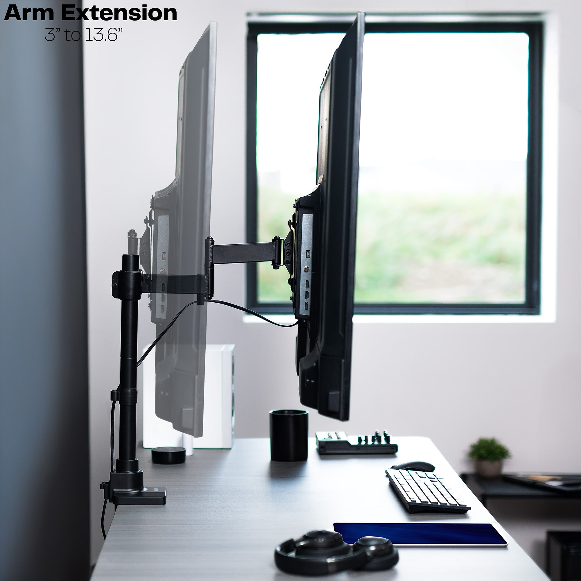 Low profile TV desk mount with articulating arm with cable management.