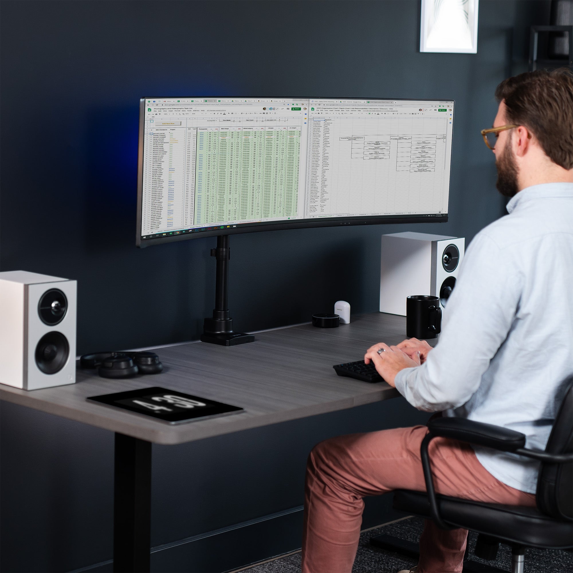 Low profile TV desk mount with articulating arm with cable management.