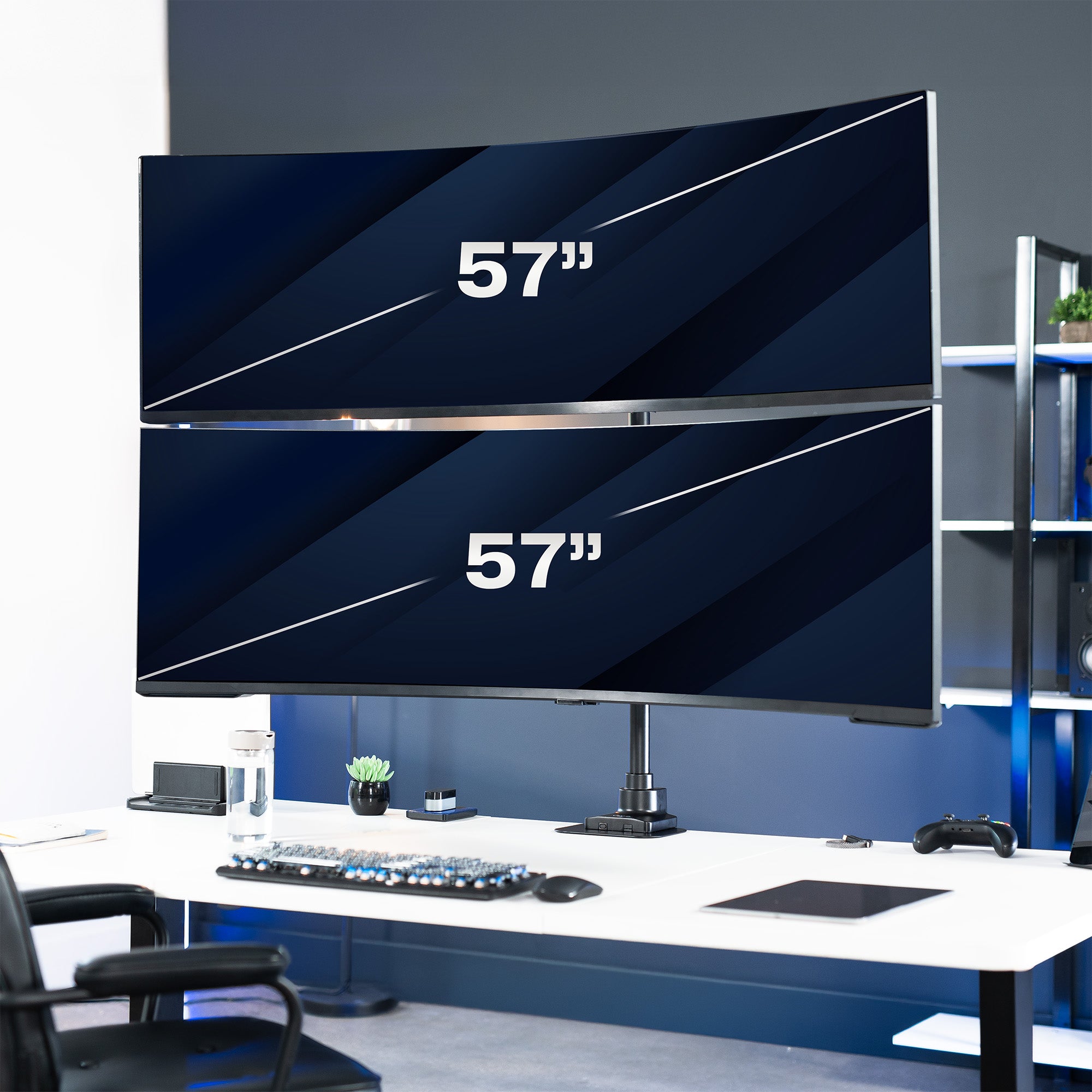 Large dual-monitor setup on a desk with office furniture in the background