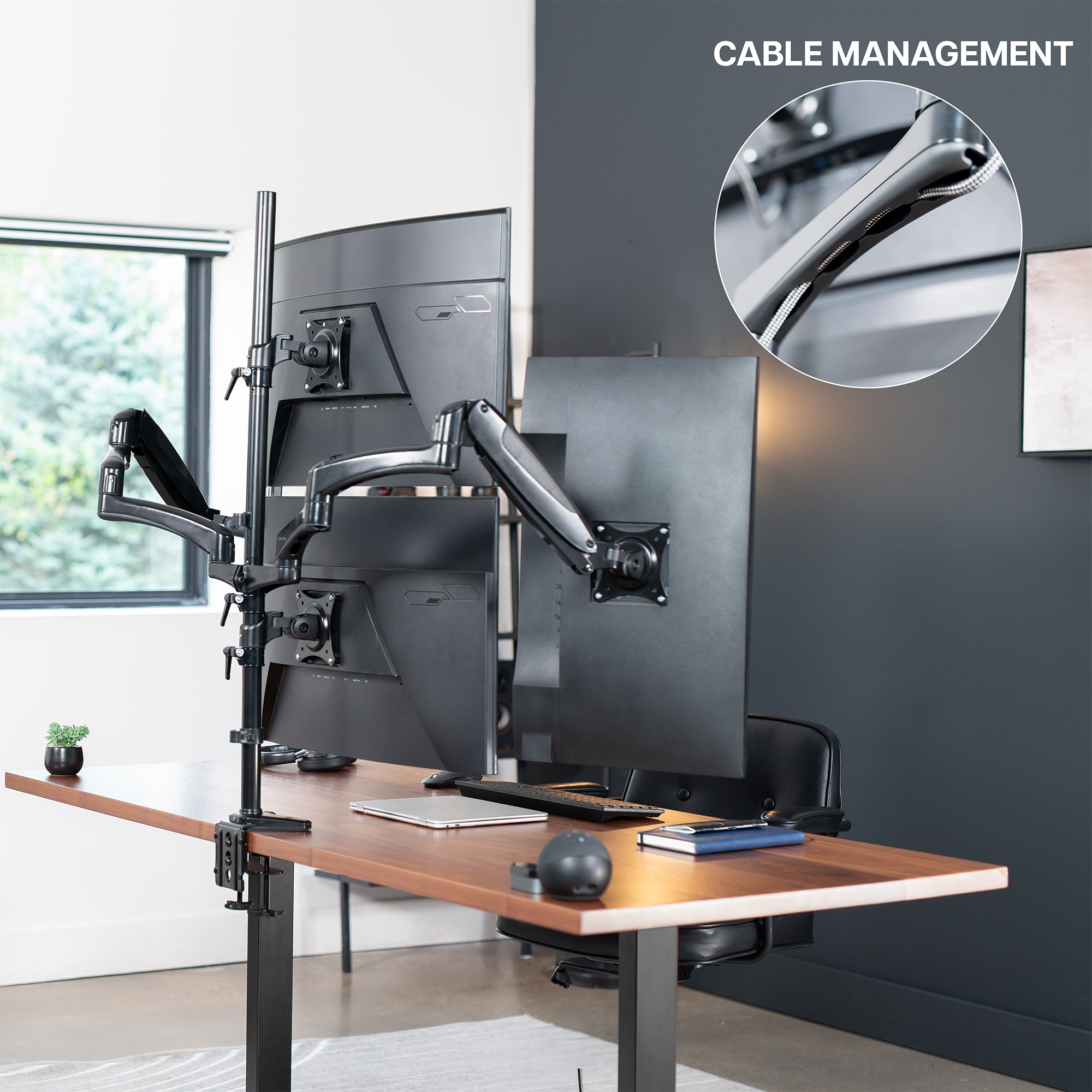 Modern office setup with quad monitor stand and cable management feature.