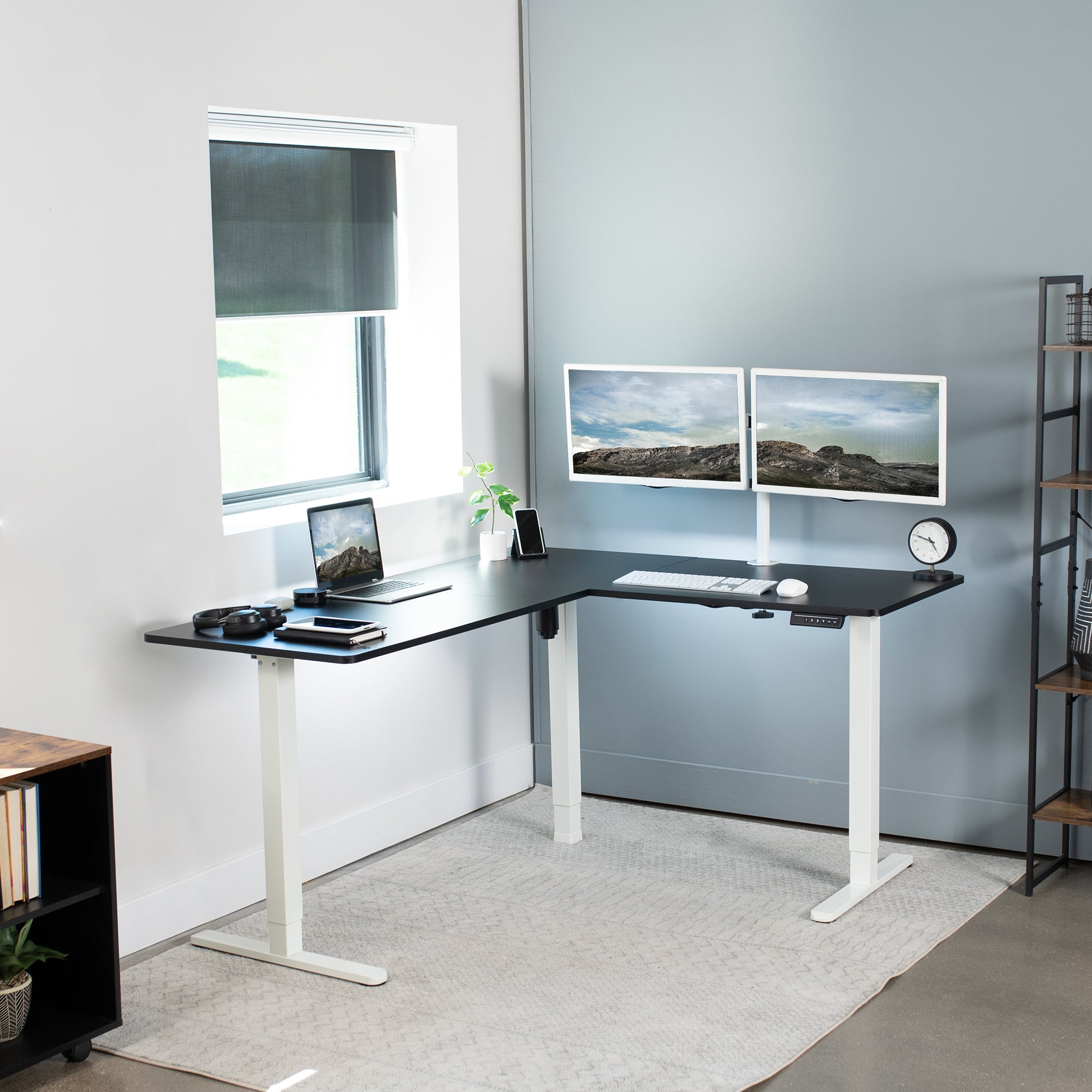 Electric heavy-duty corner desk workstation for modern office workspaces.