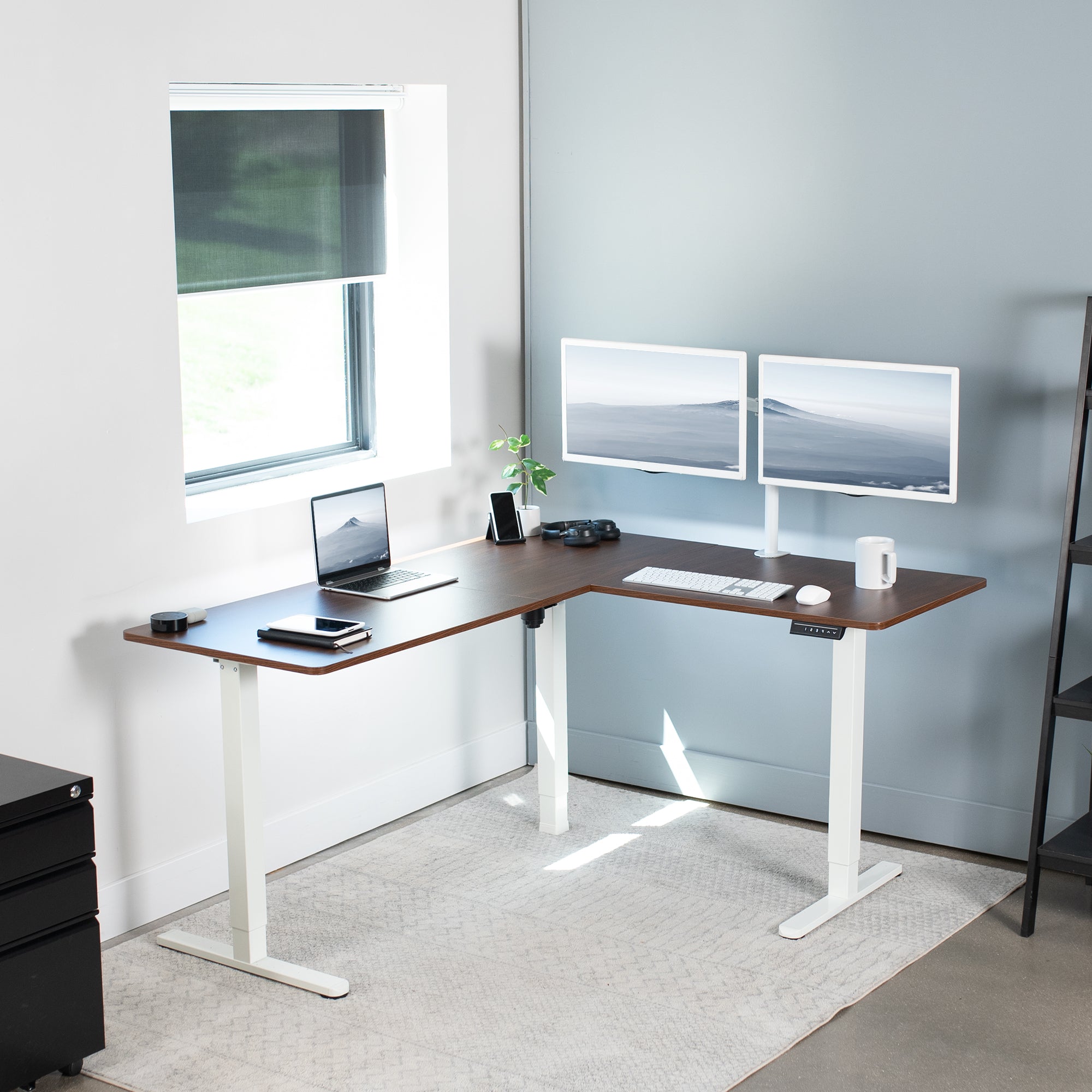 Electric heavy-duty corner desk workstation for modern office workspaces.