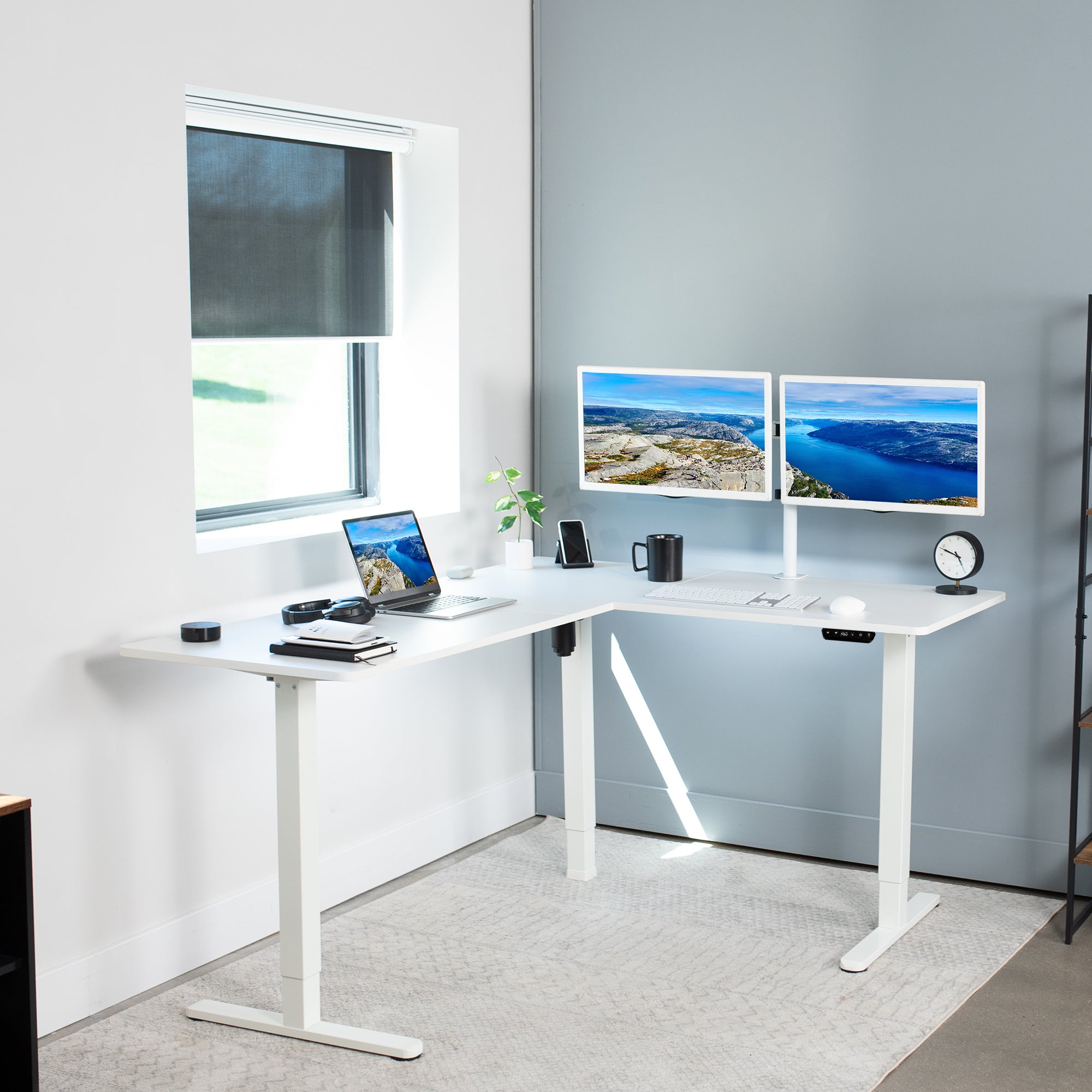 Electric heavy-duty corner desk workstation for modern office workspaces.