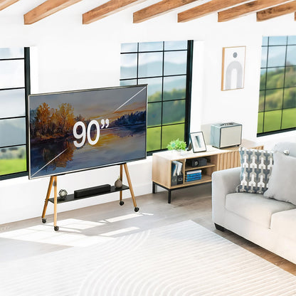 Modern living room with a large TV on a TV stand with shelf displaying '90”, wooden floor, and white walls.