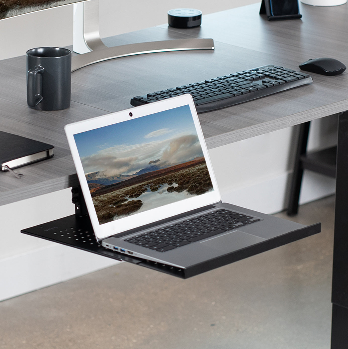 Under desk adjustable laptop tray lets you have comfortable typing angles as you work.