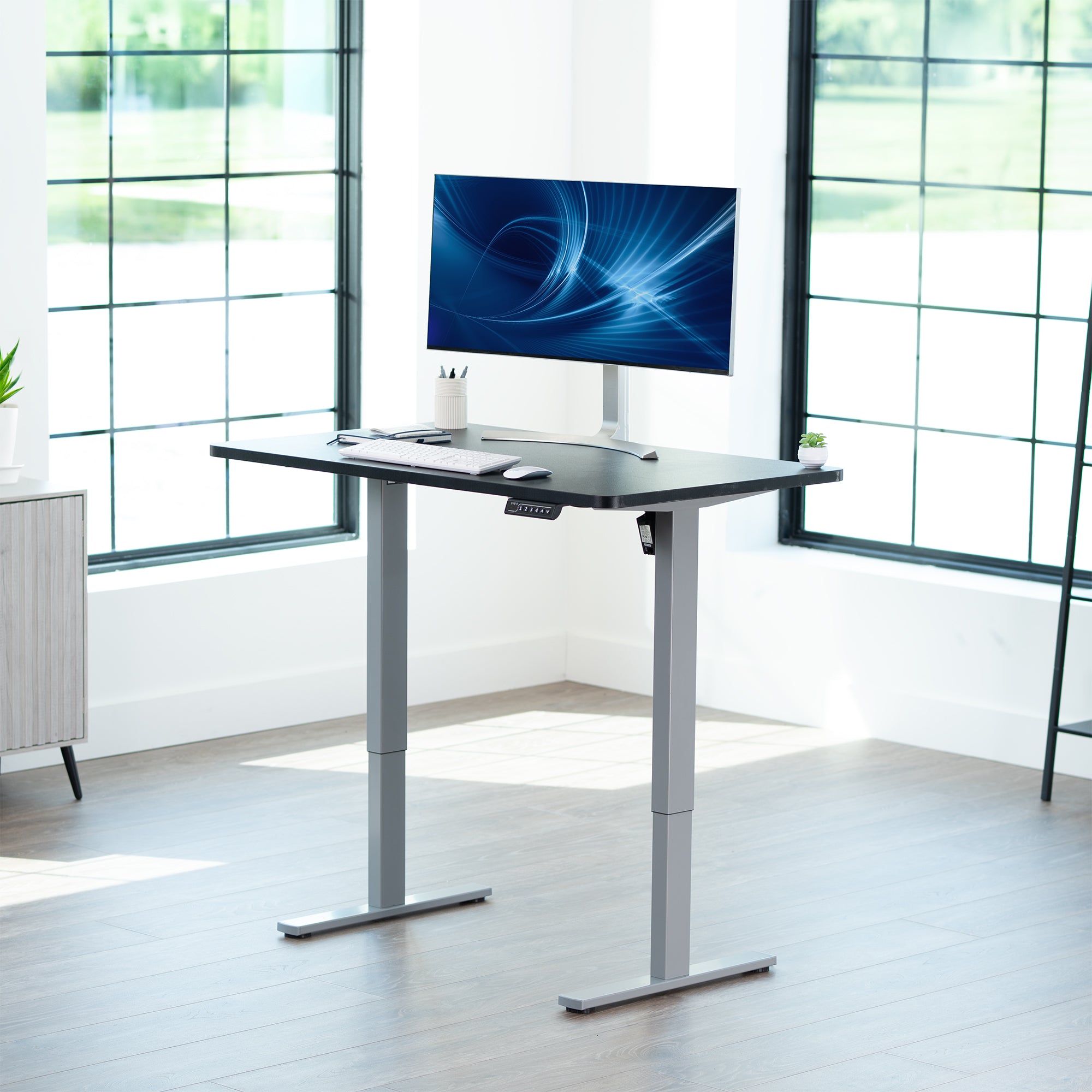 Sturdy ergonomic sit or stand active desk workstation with adjustable height using smart control panel.