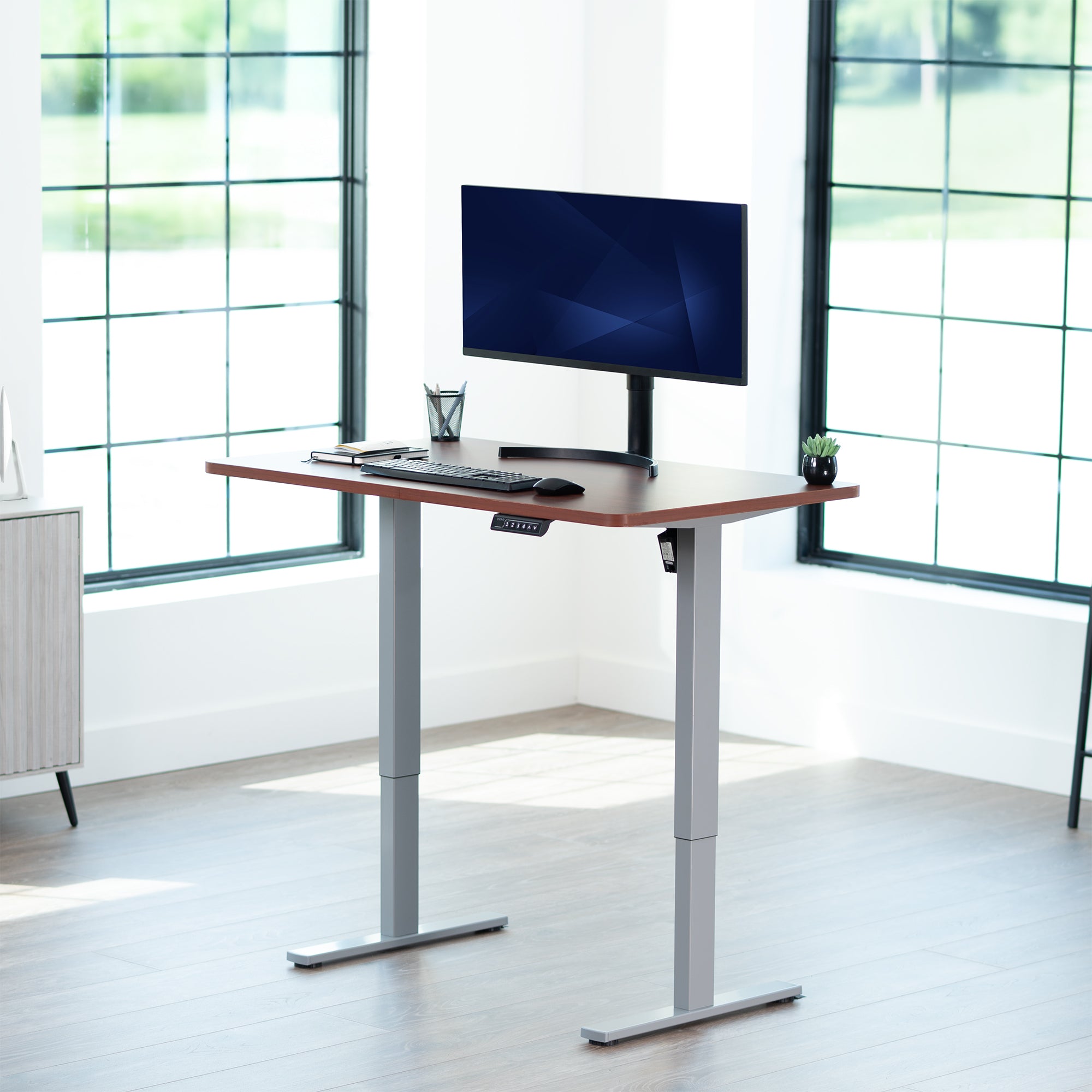 Sturdy ergonomic sit or stand active desk workstation with adjustable height using smart control panel.