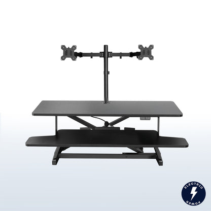 Sit to stand desk riser and dual monitor mount with electric height adjustment.