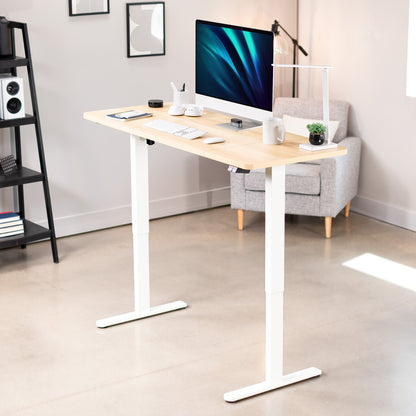 Modern standing desk with a computer setup in a home office setting.