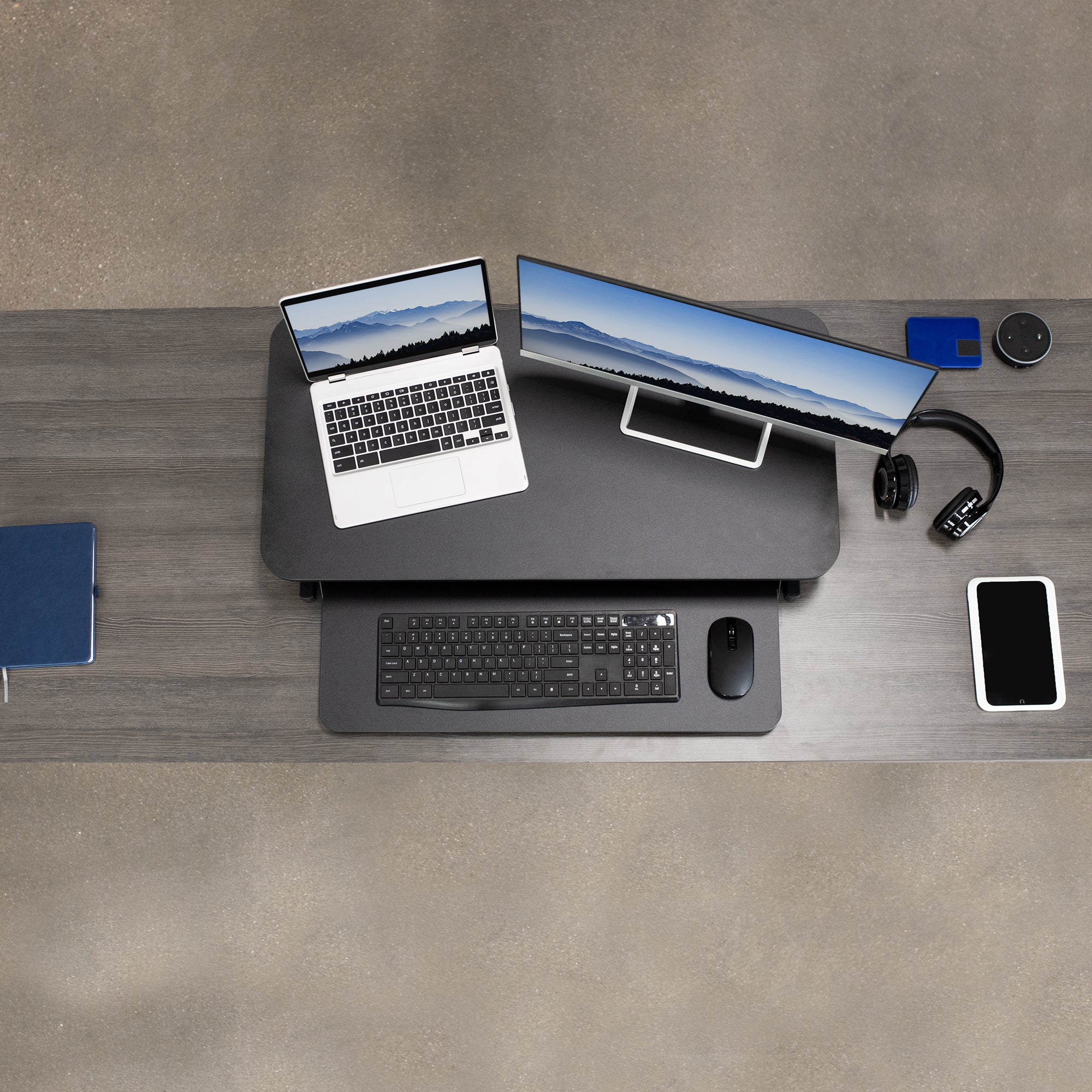 Heavy-duty height adjustable desk converter monitor riser with 2 tiers.