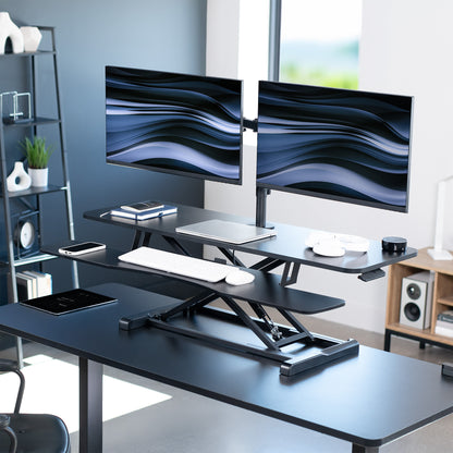 Sturdy height adjustable desk converter with articulating dual monitor mount.