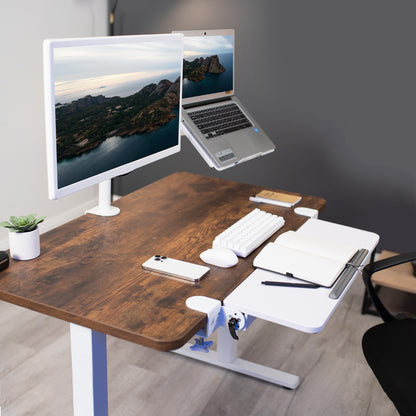 Wooden desk with computer setup including monitor, laptop, keyboard, and mouse.