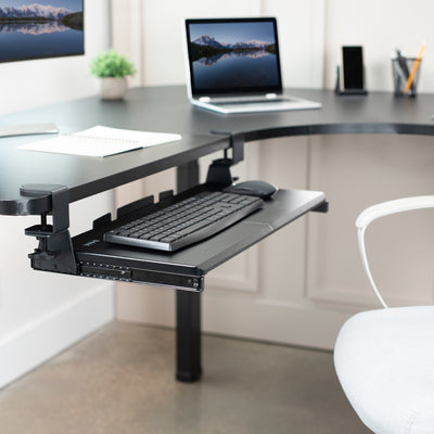 Under desk corner keyboard tray platform with adjustable swivel clamps for an ergonomic workspace.