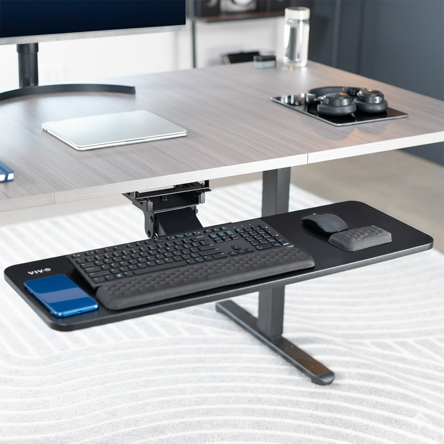 Adjustable under desk pull out keyboard tray mount with included padding.