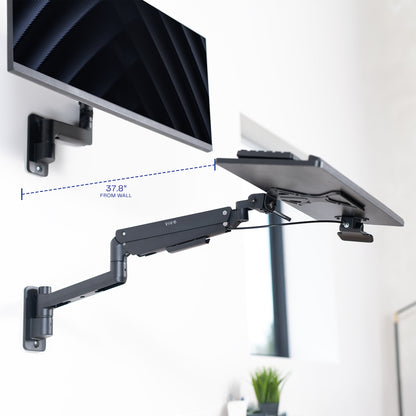 A wall mounted keyboard tray with a pneumatic mechanism