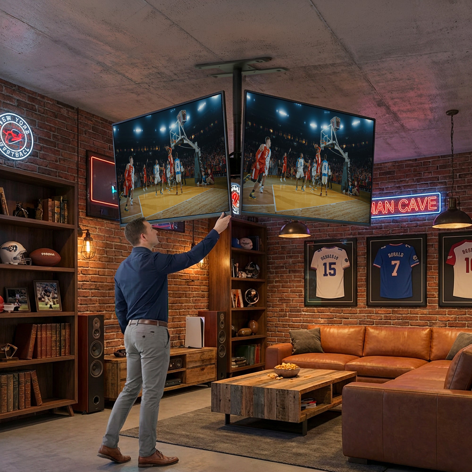 Man adjusting a mounted TV, hanging from ceiling in a living room with sports-themed decor.
