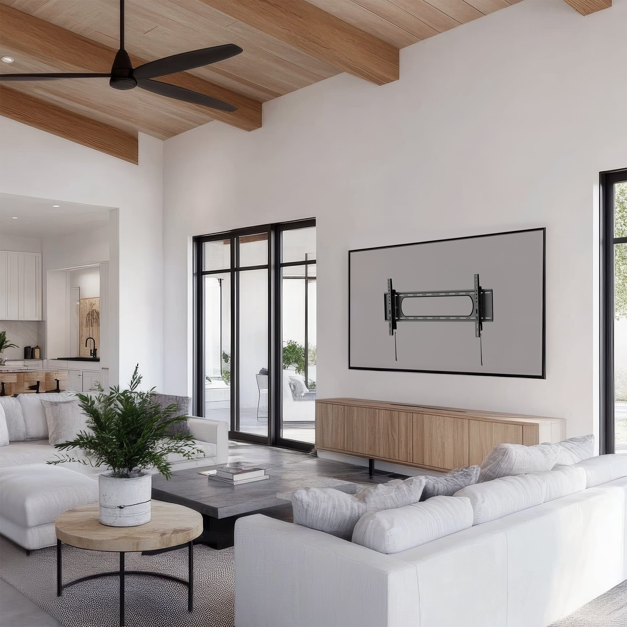A black tilting wall mount for TVs in a living room setting. 
