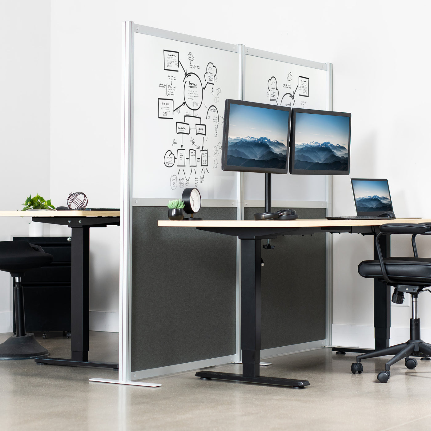 Freestanding privacy panels with whiteboard surfaces for an ergonomic office partition solution.