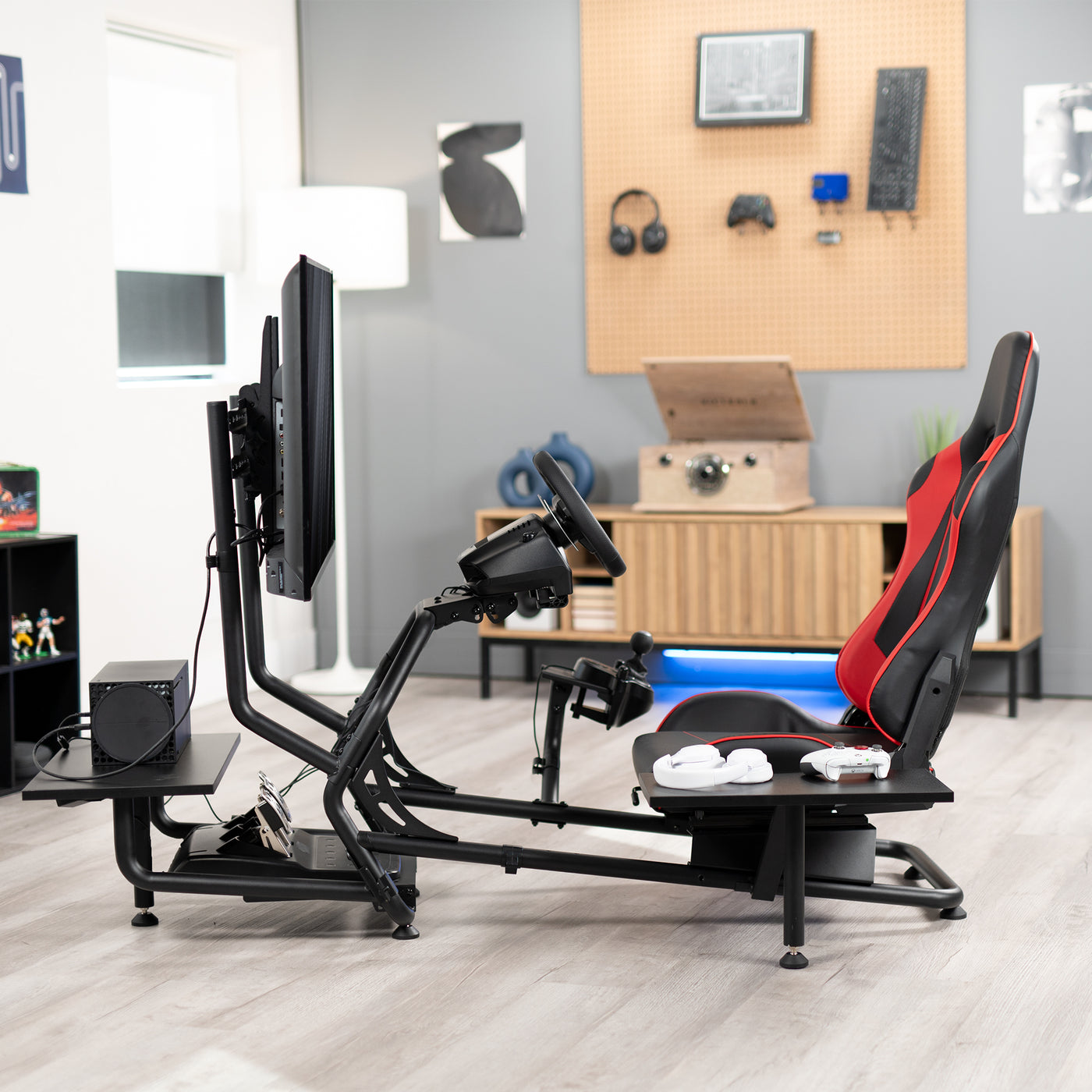 Racing simulator cockpit gaming chair with TV mount, PC shelf, and side shelf.