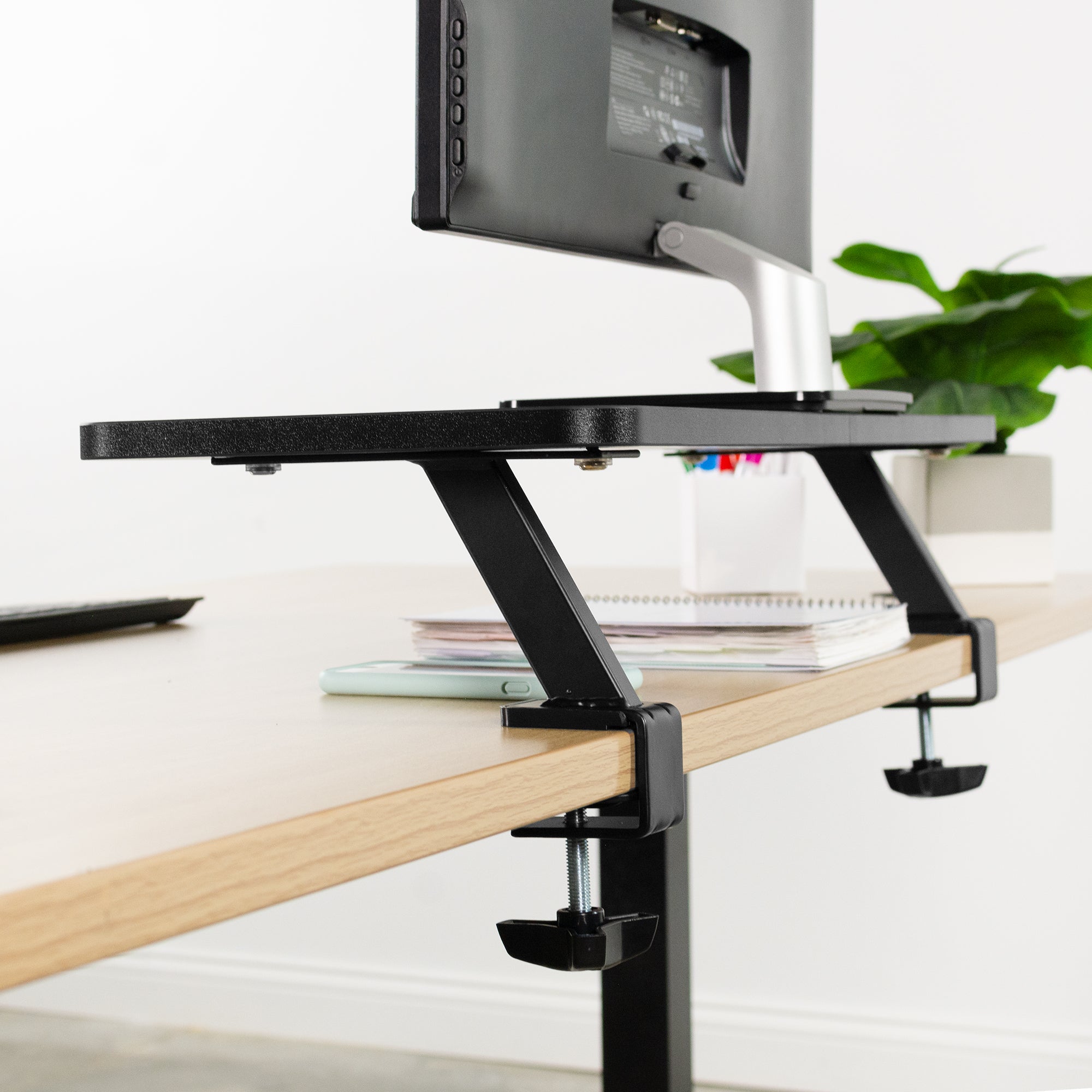 Heavy-duty clamp-on desk converter monitor riser.
