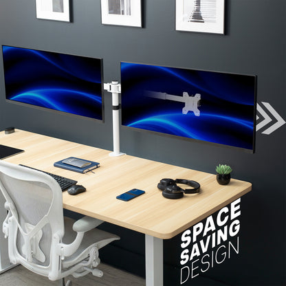 Modern office setup with dual monitors on a desk, chair, and decor.