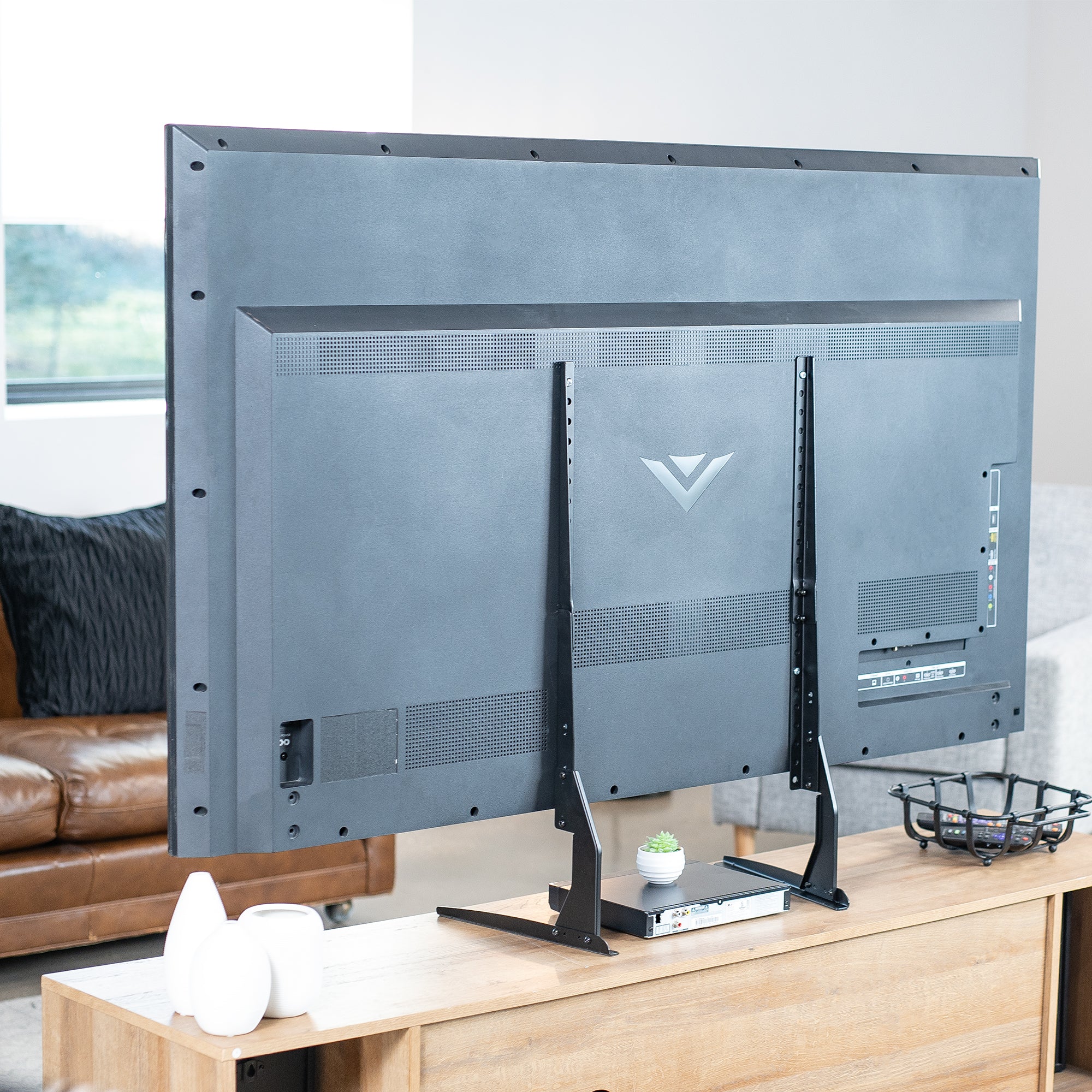 Large flat-screen TV on a stand in a living room setting