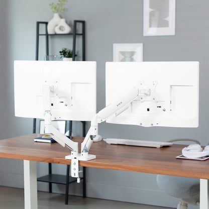 Sturdy adjustable mechanical arm dual monitor ergonomic desk stand for office workstation.