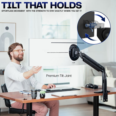 Man sitting at a desk with a monitor on a adjustable arm, emphasizing the tilt feature.
