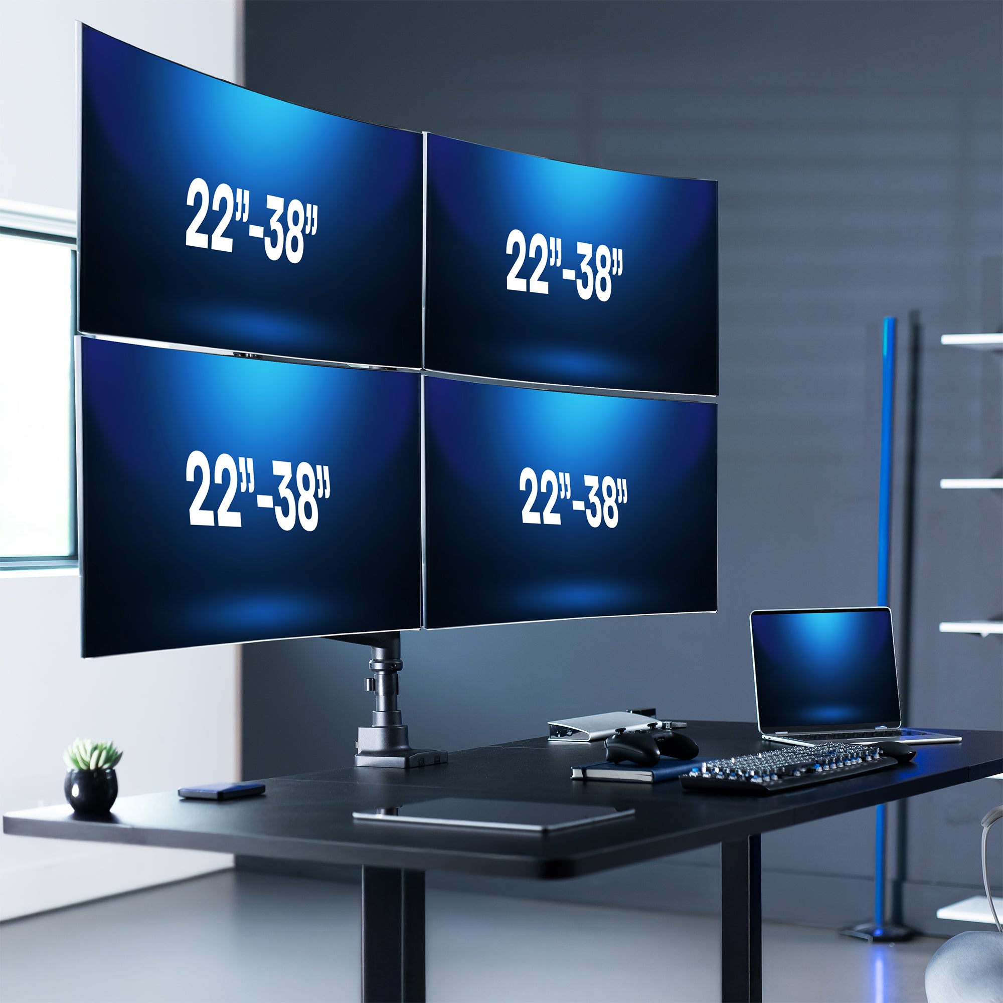 Four monitors on a desk displaying screen size text.