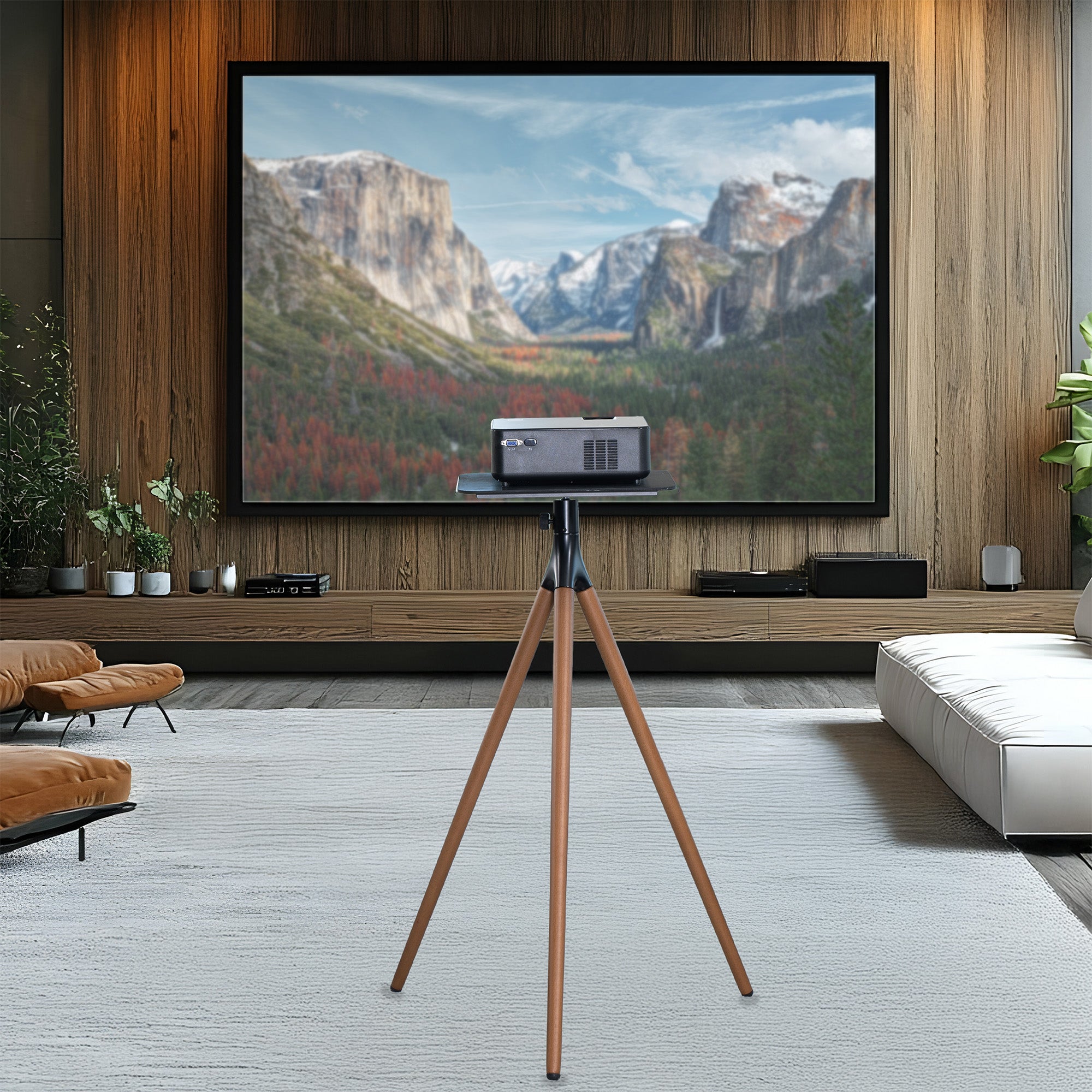 Projector on a tripod displaying a mountain scene in a living room.
