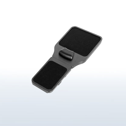 Strap on chair armrest with mouse pad.