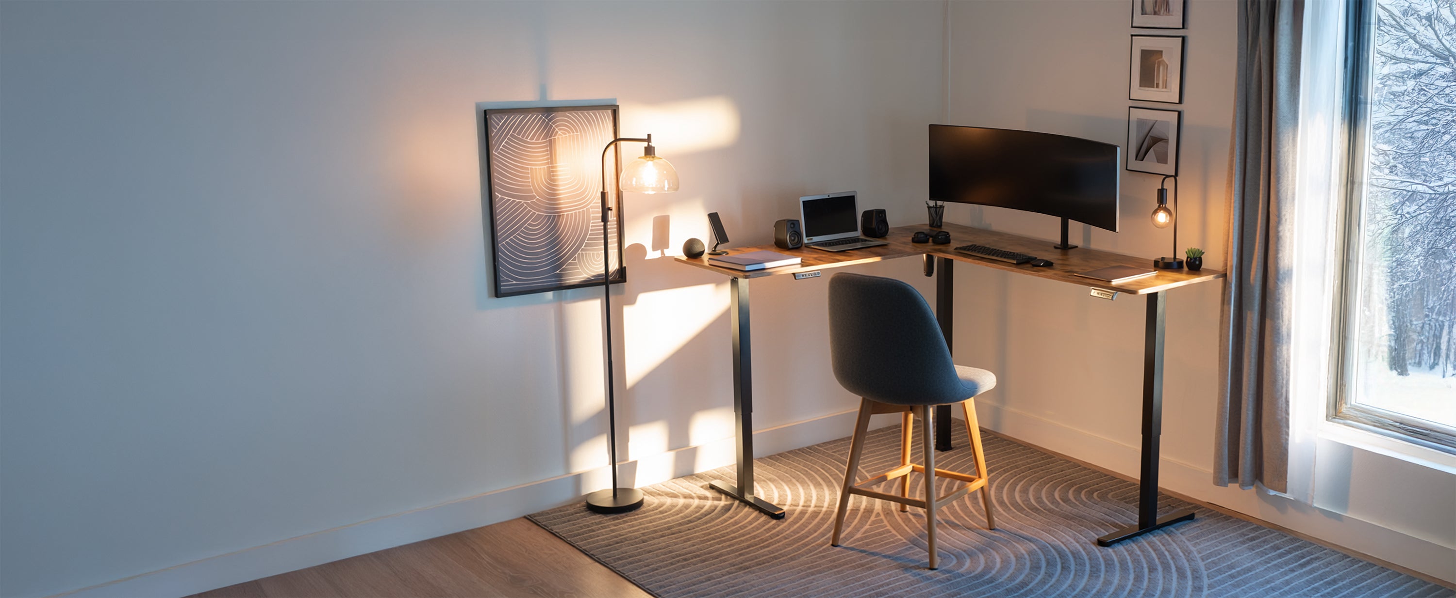 corner standing desk in room with decor and large window looking out into a winter scene