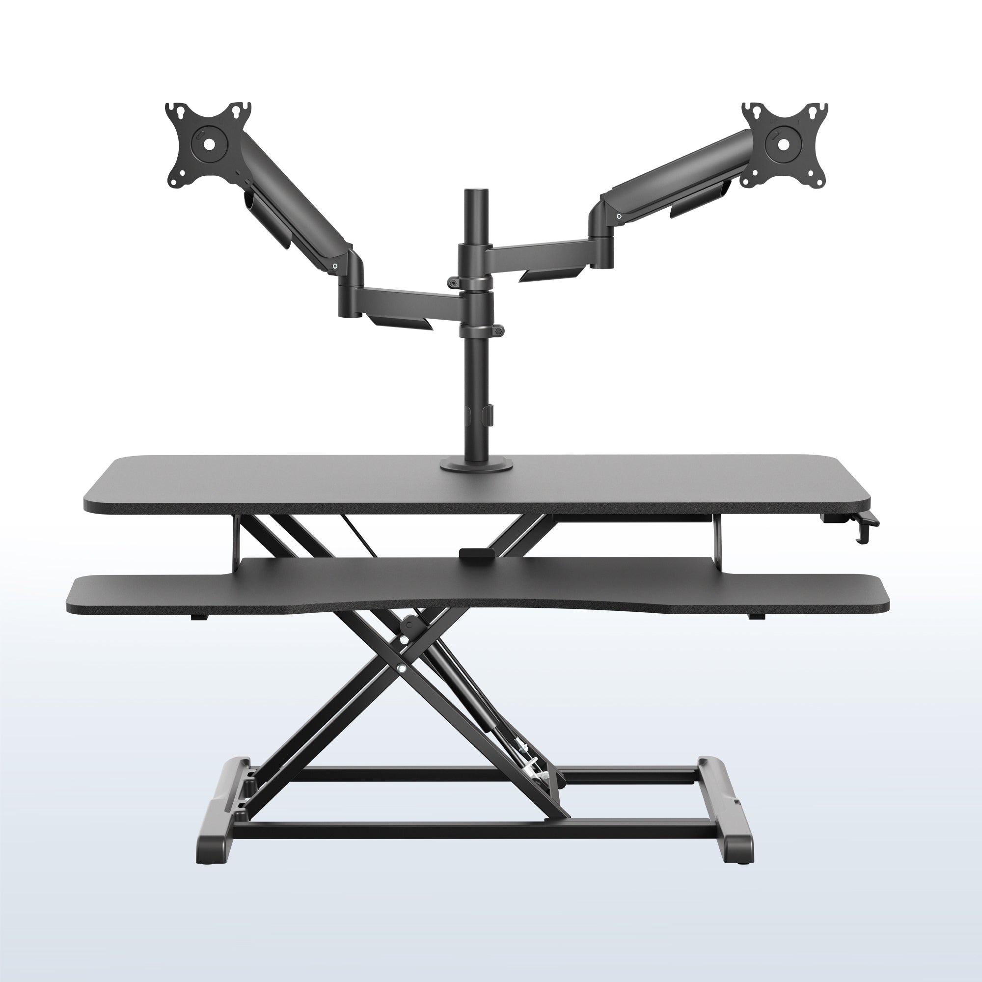 42 inch height adjustable desk riser with articulating mechanical dual monitor mount.